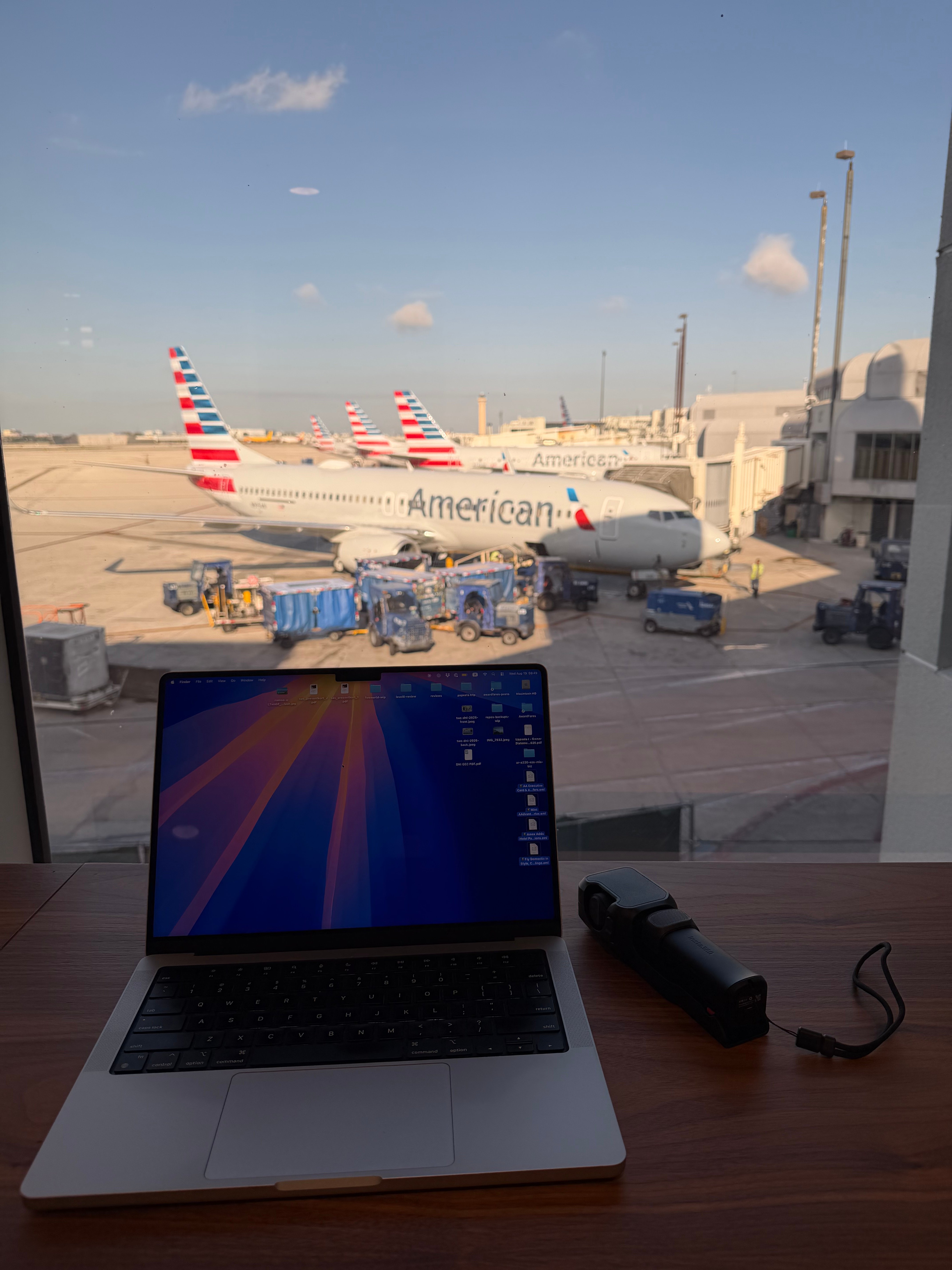 Laptop beside the window with American Airlines aircraft outside the Turkish Airlines Lounge.