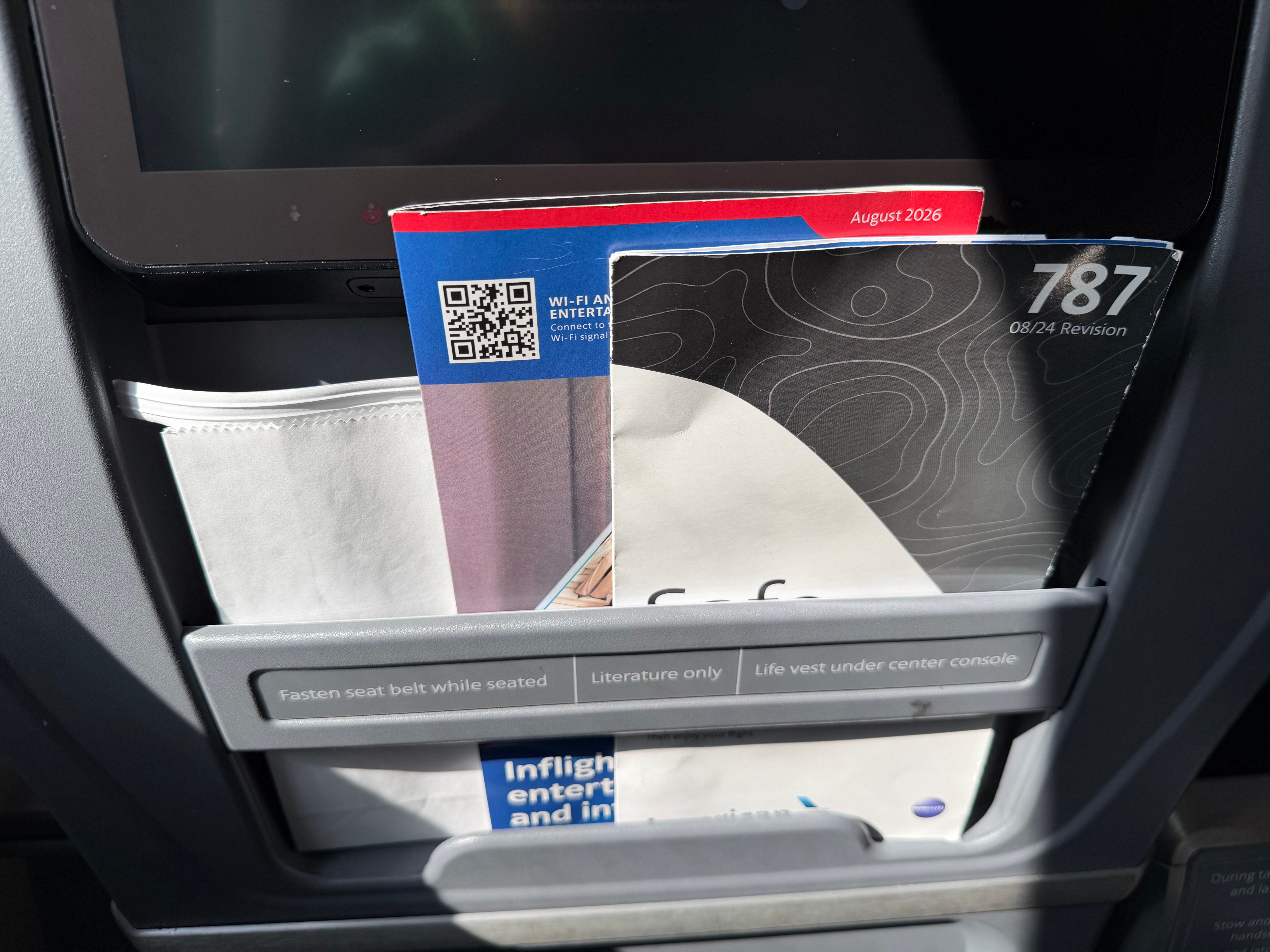 Seatback pocket and safety card in the American 787-8 Main Cabin Extra cabin.