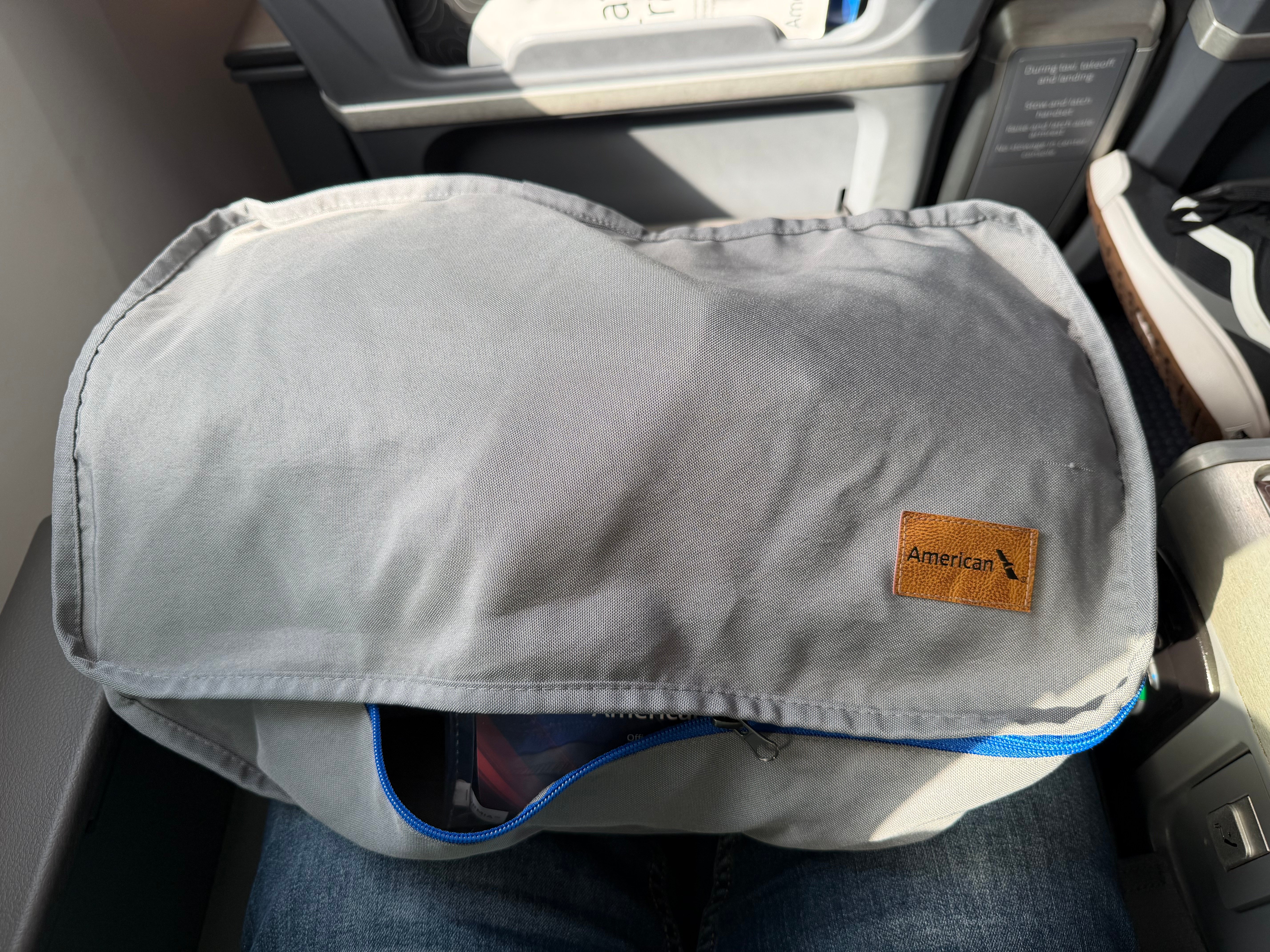 Closed welcome bag at an American Airlines Main Cabin Extra seat.