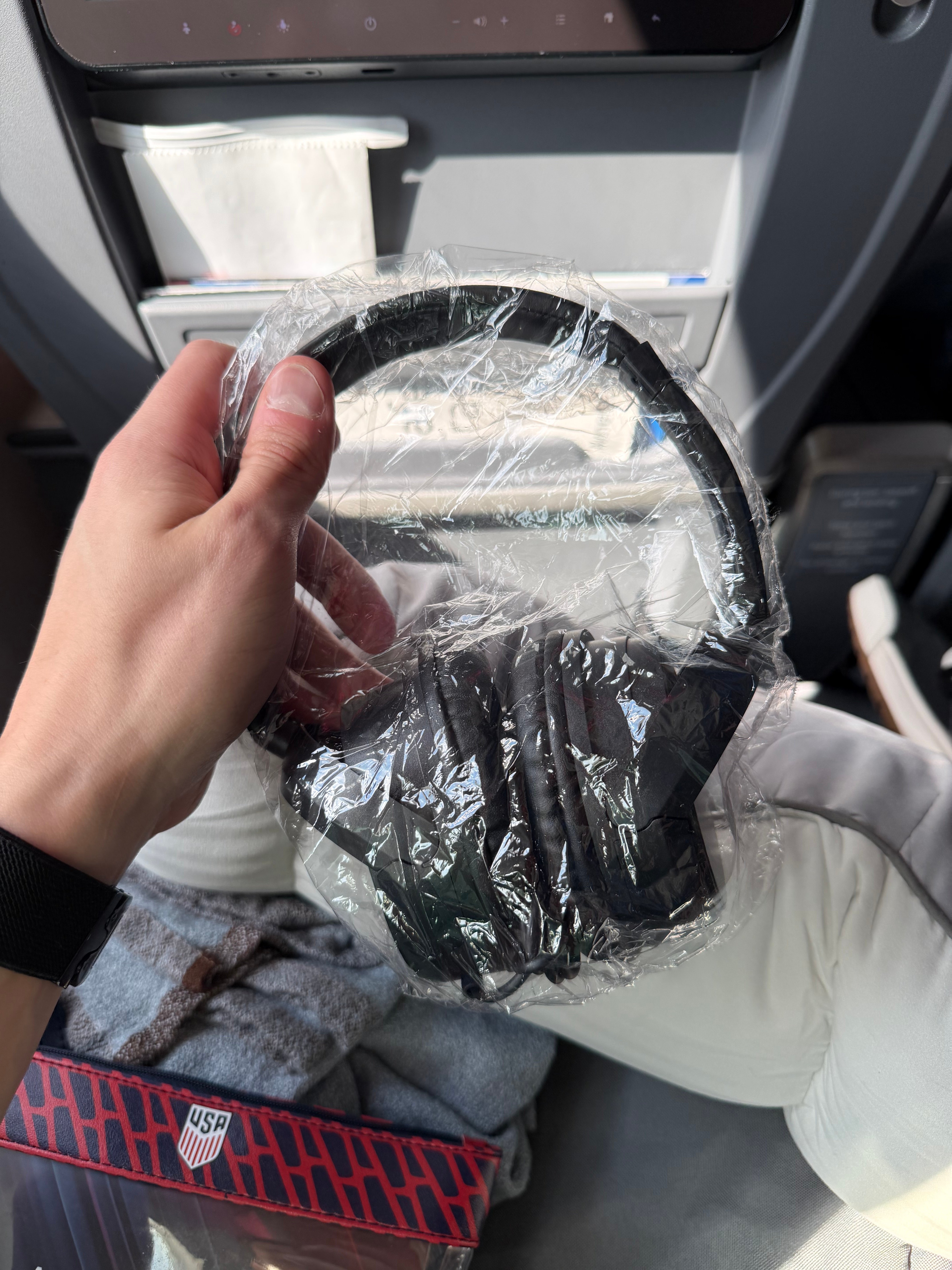 Wrapped headphones provided in American Airlines Main Cabin Extra.