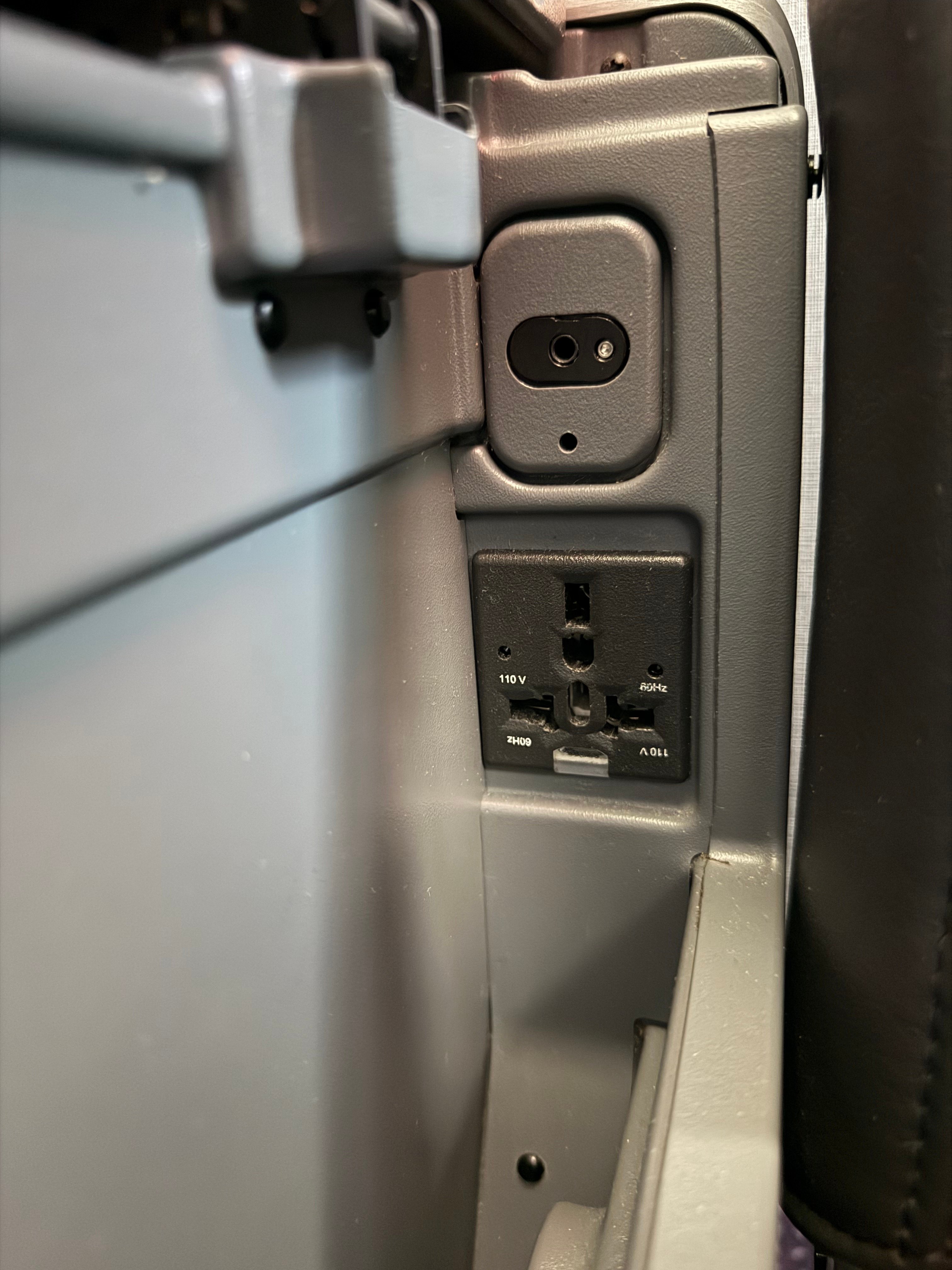 Power outlet beside the American 787-8 Main Cabin Extra seat.