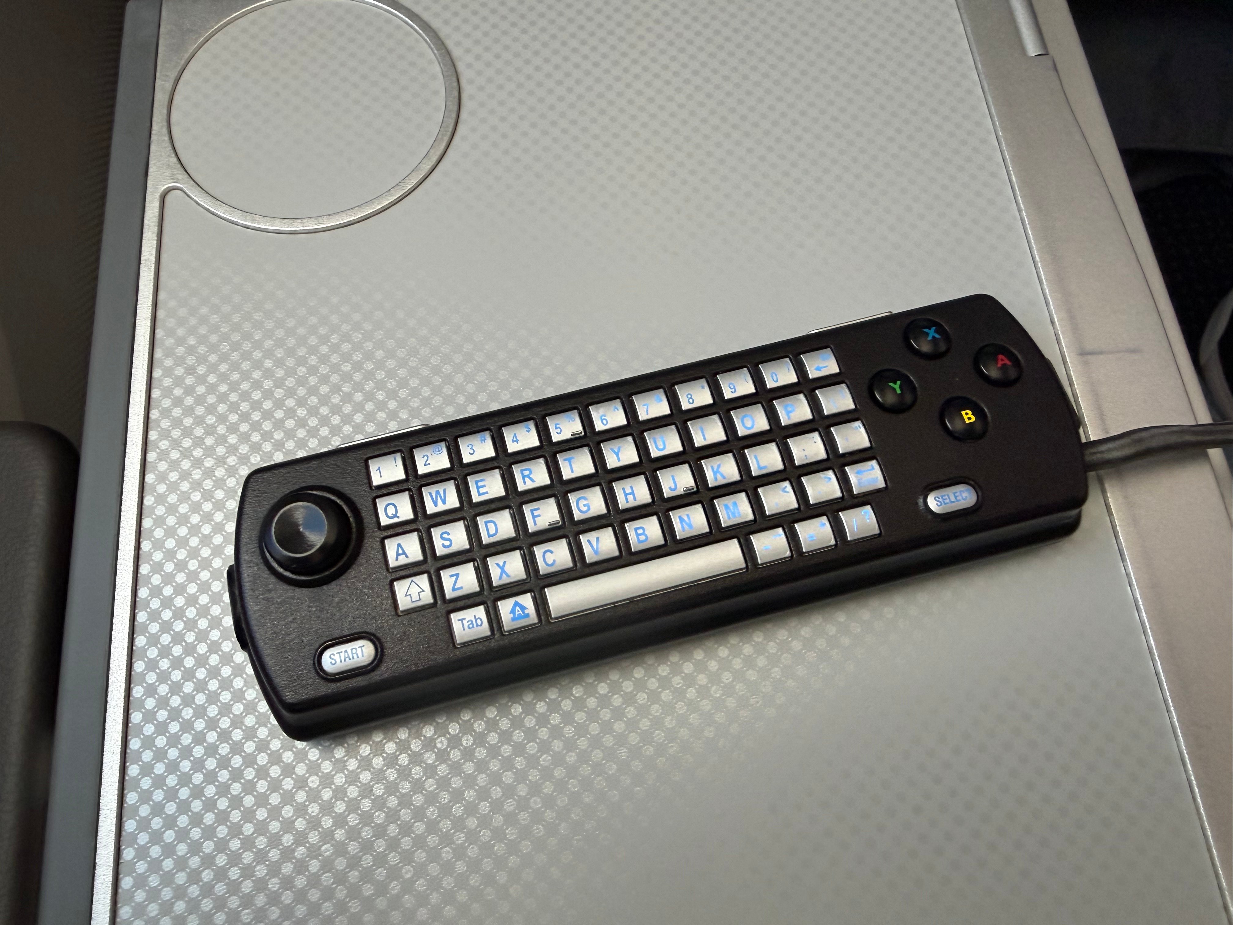 Keyboard on the back of the American Airlines entertainment remote.