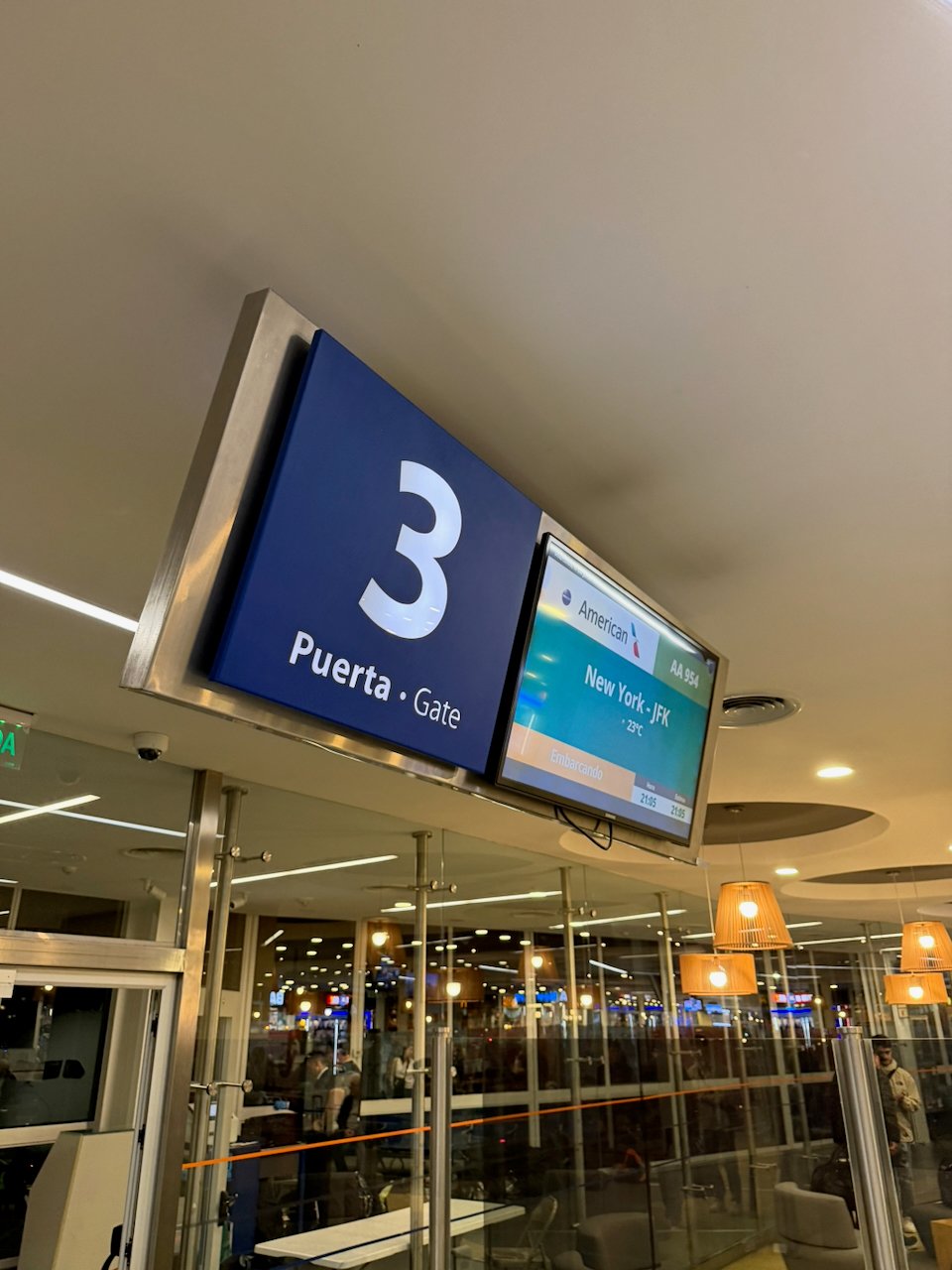 Boarding gate 3 sign at Ezeiza for the American Airlines flight to New York.