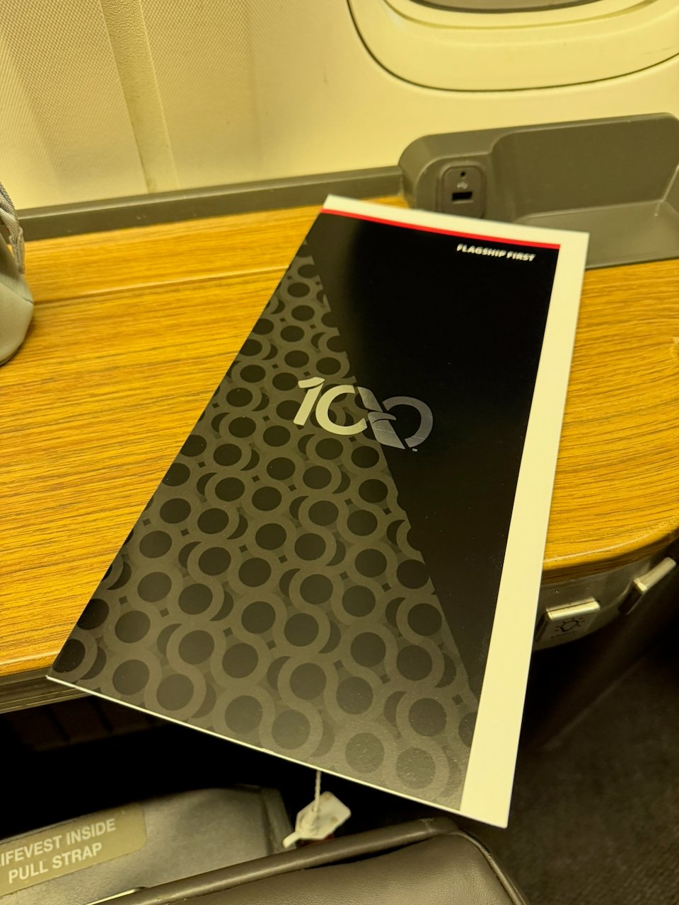 American Airlines centennial menu waiting at the Flagship First seat.