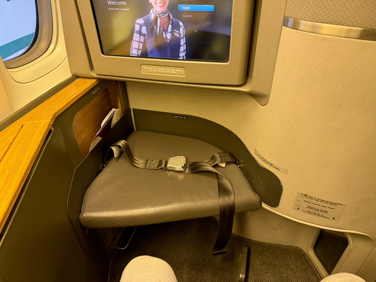 Ottoman and seatback IFE screen at the American Flagship First suite.