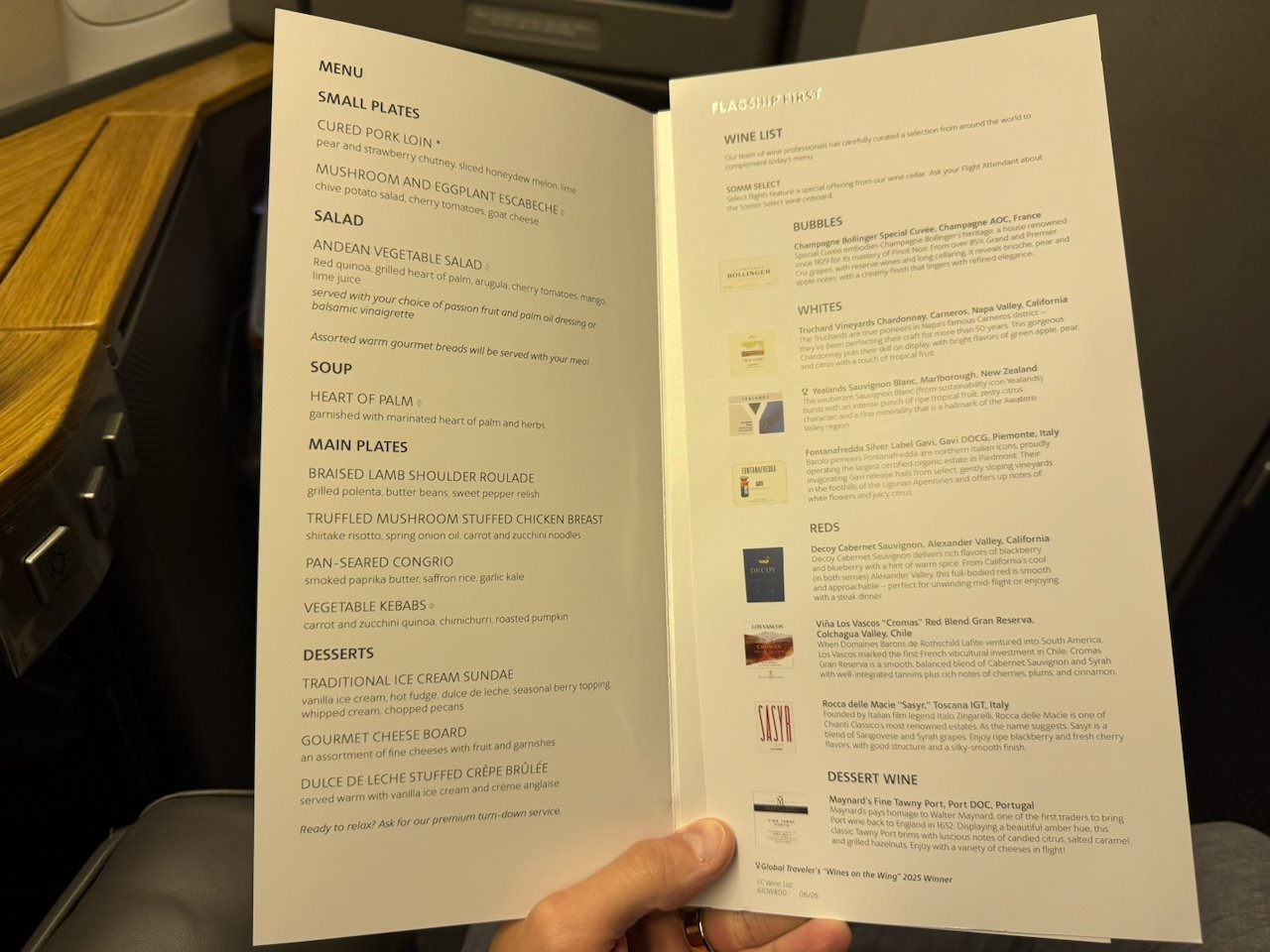 Flagship First menu and award-winning wine list open at the seat.