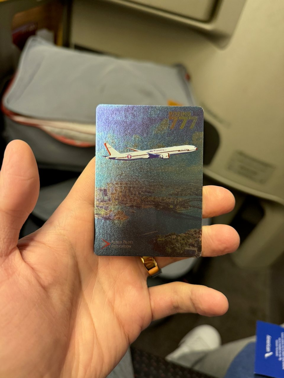 Holographic American 777 pilot trading card handed out in Flagship First.