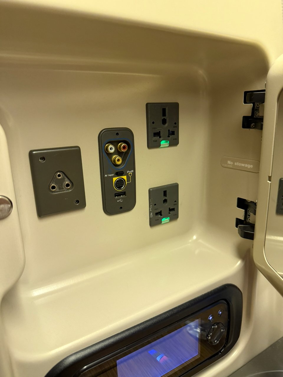 AC power and USB outlets panel at the Flagship First seat.