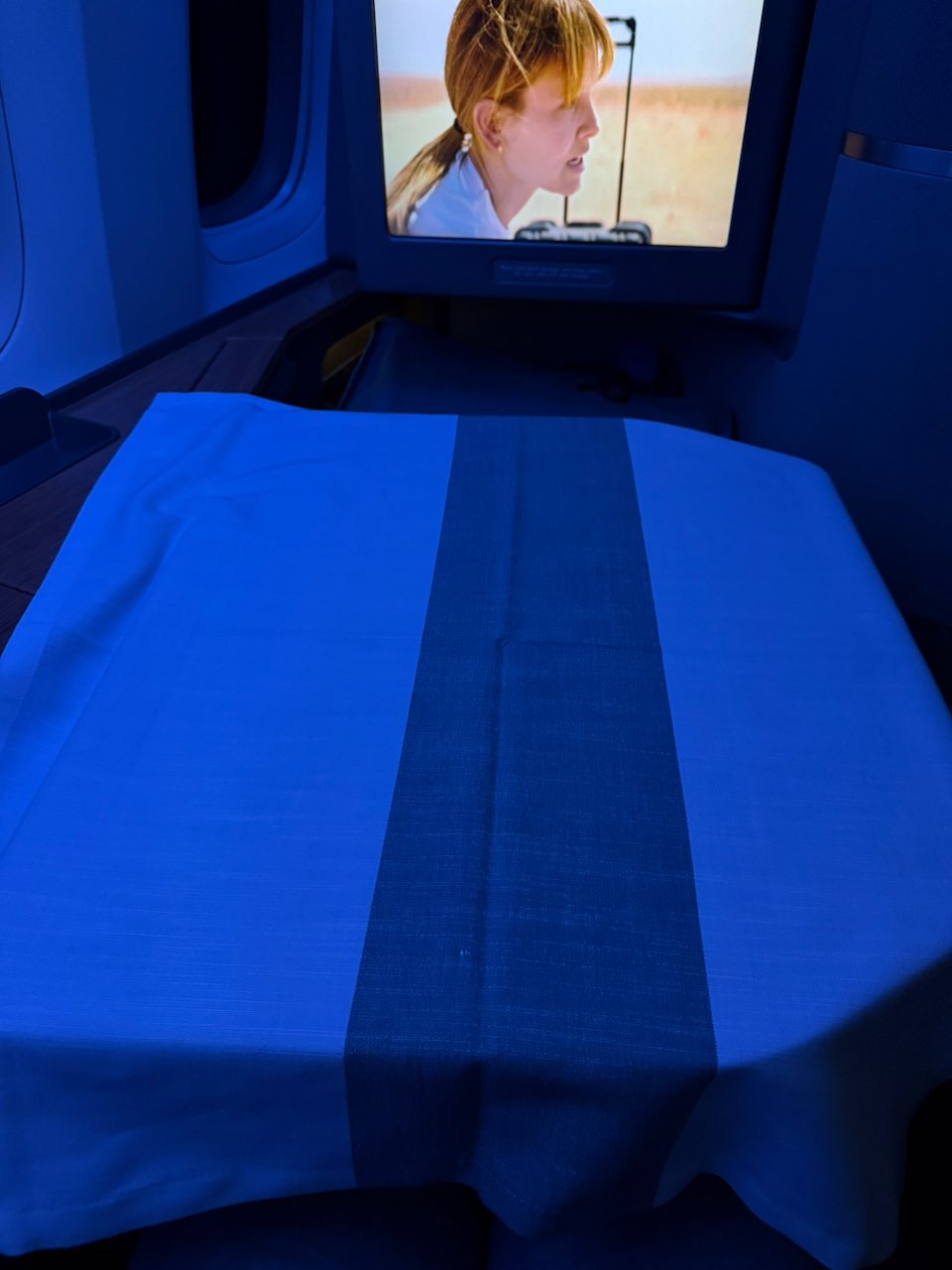 Tablecloth set for dinner at the Flagship First seat.