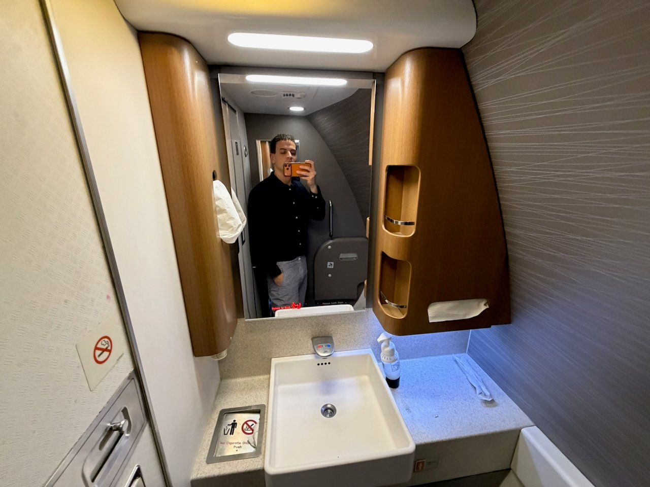 Mirror and vanity in the American Airlines Flagship First lavatory.