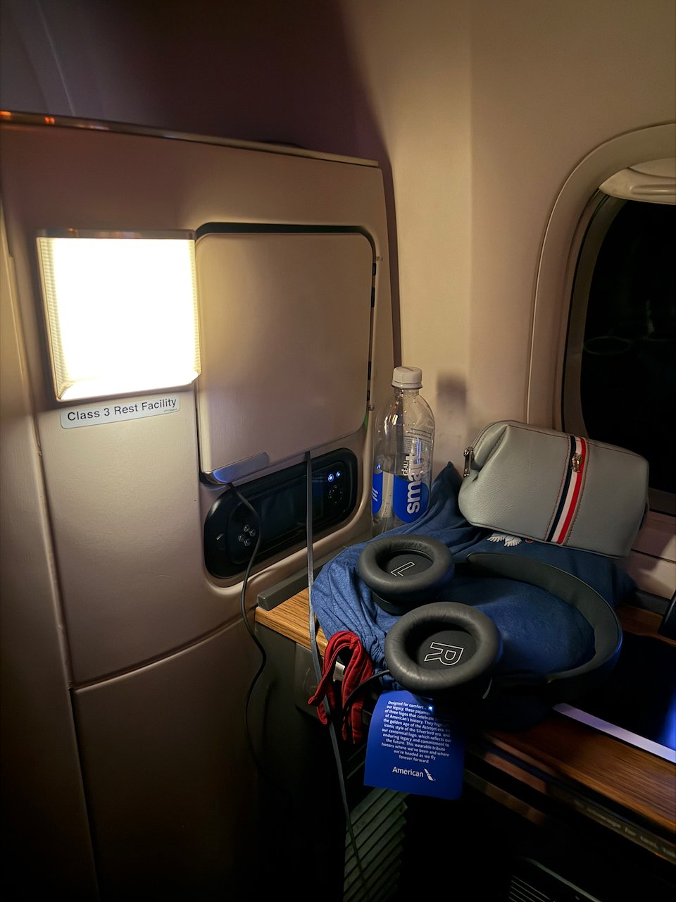 Flagship First bed made up with headphones ready for sleep.