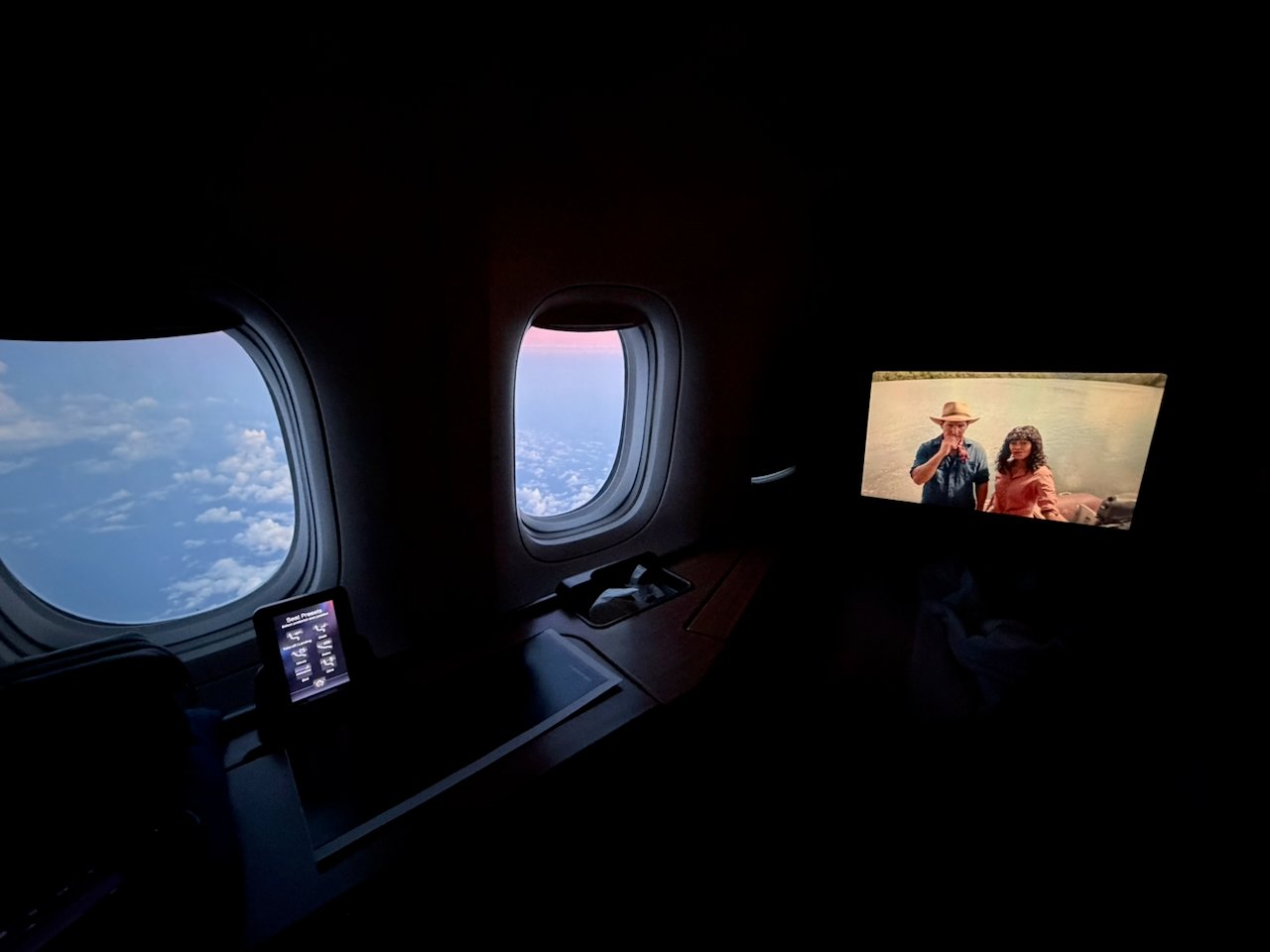 Movie playing with sunrise out the window in Flagship First.