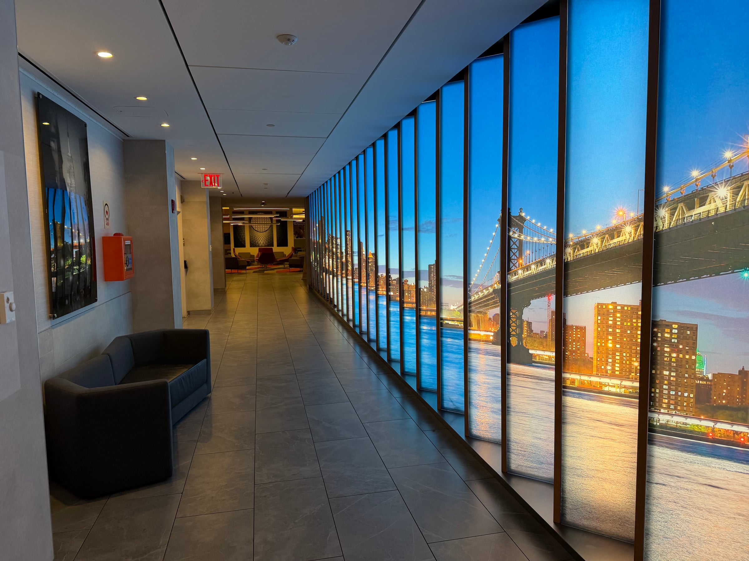 Window-lined corridor inside the Greenwich Lounge at JFK.