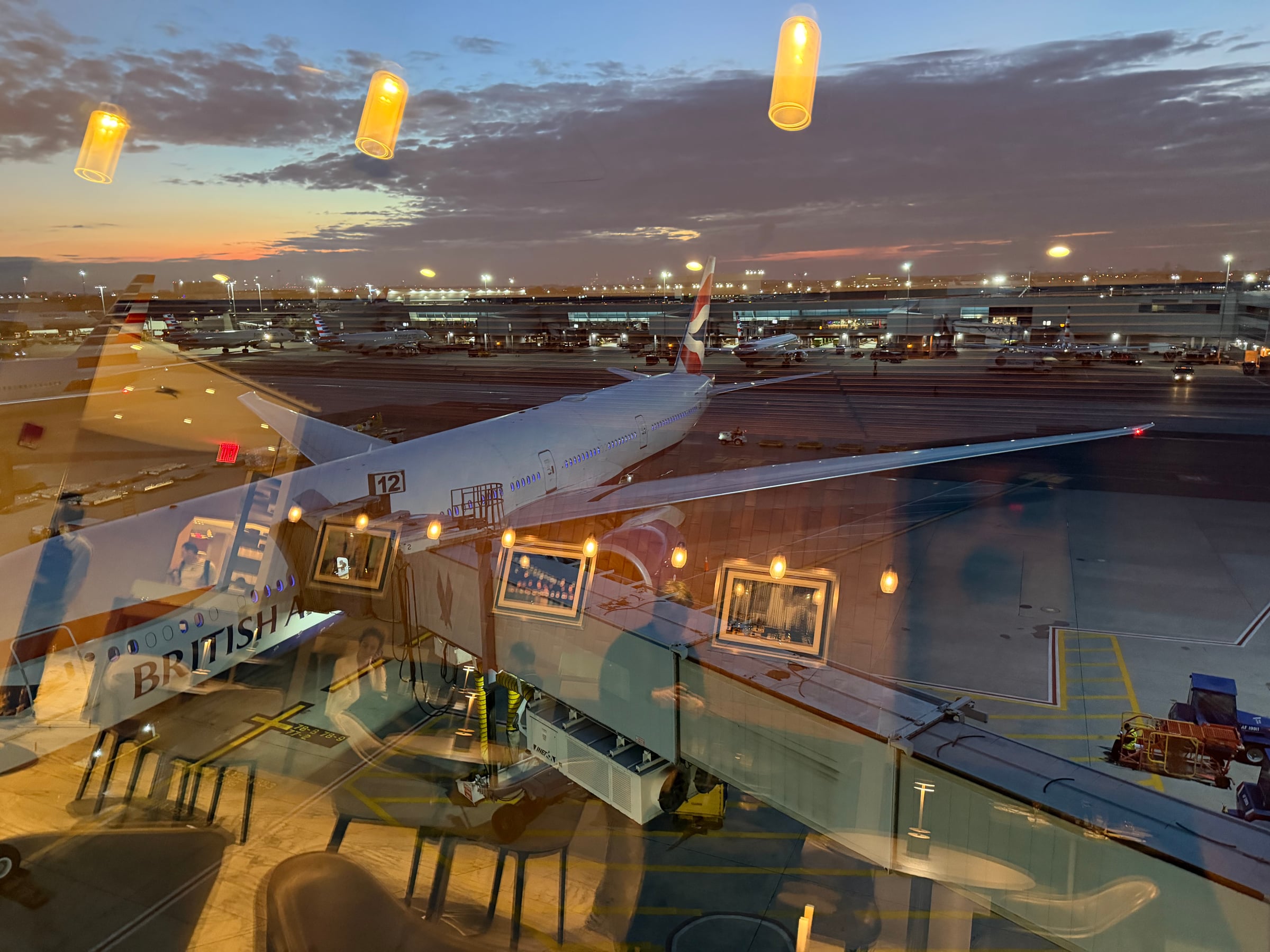 Runway and aircraft view at sunset from the Greenwich Lounge.