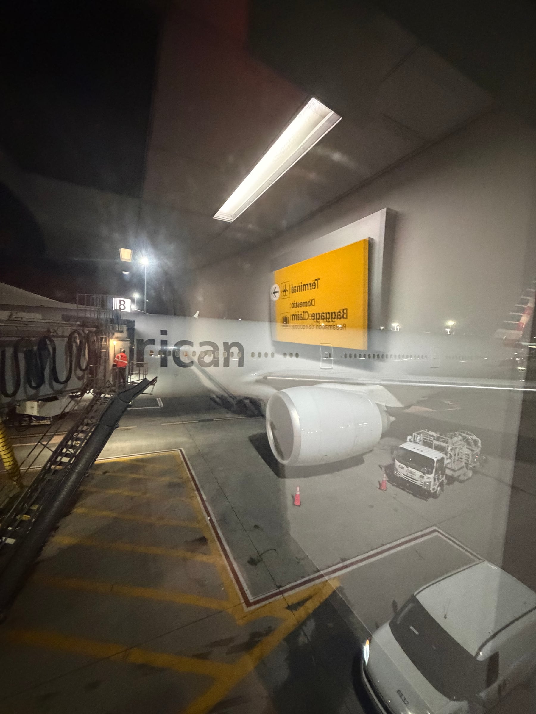 American Airlines 777-300ER wing and engine at JFK before the overnight departure.