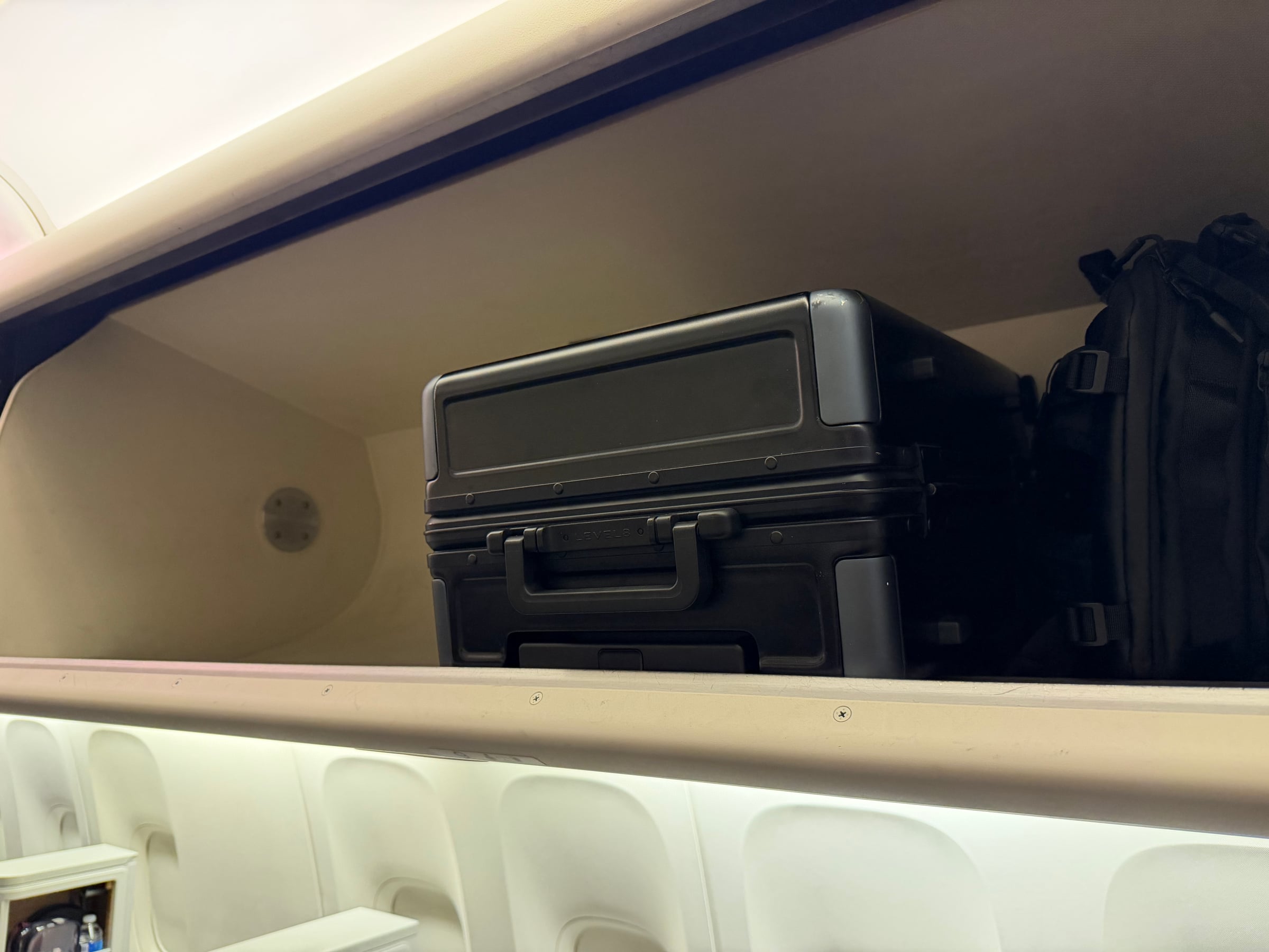 Overhead bin storage above the American 777 Flagship Business cabin.