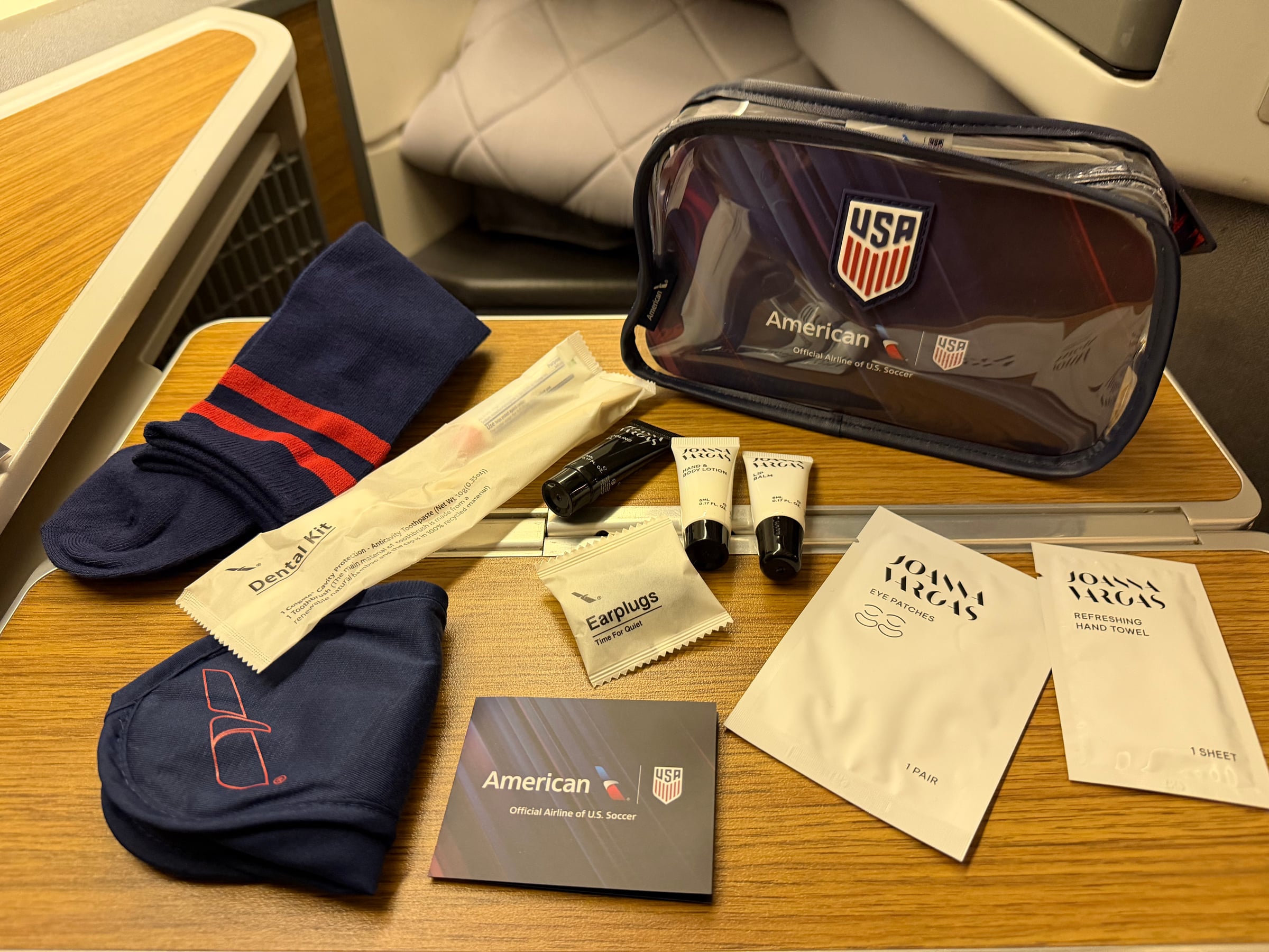 Contents of the American Airlines U.S. Soccer Business Class amenity kit laid out at the seat.