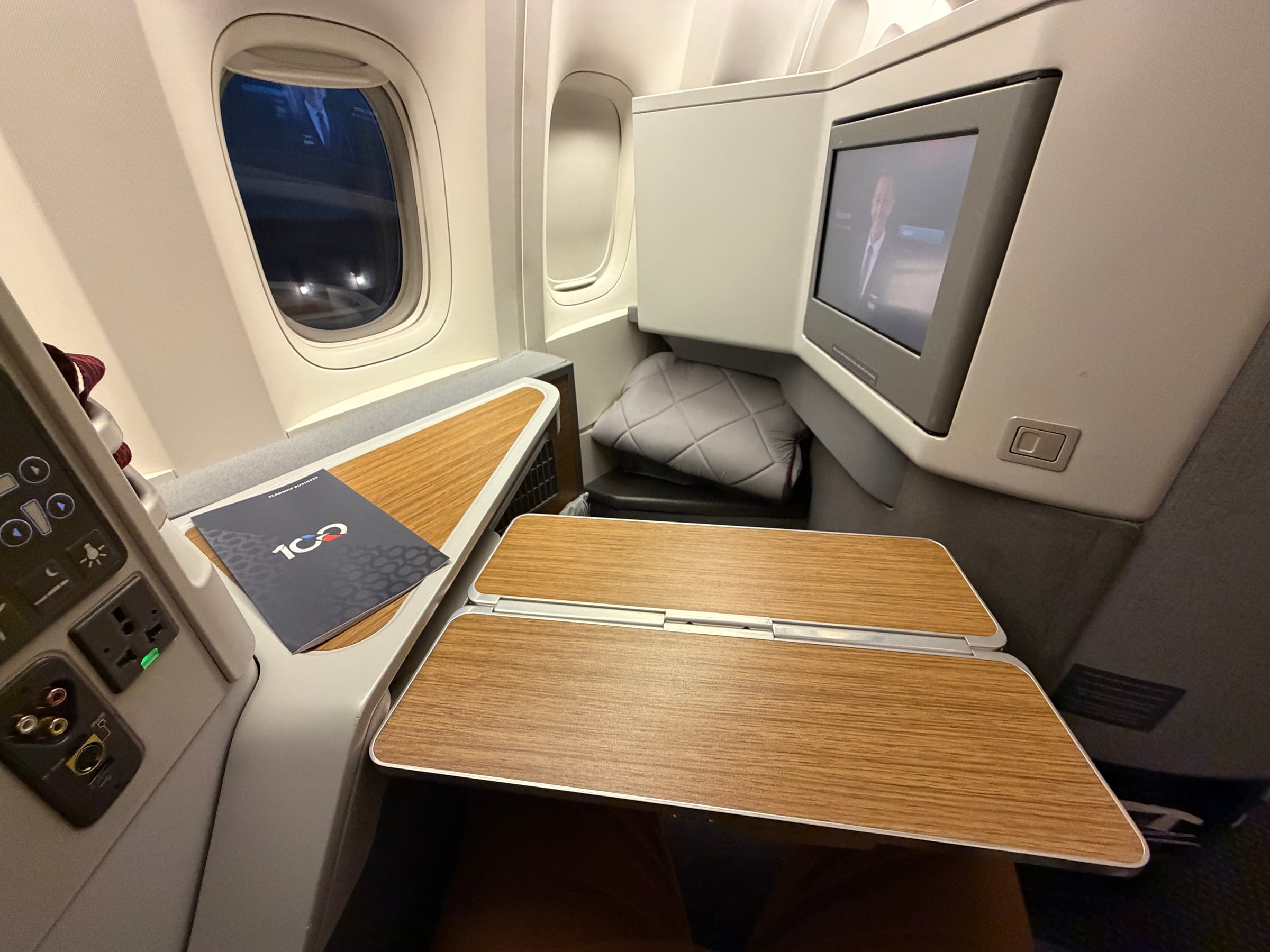 Tray table deployed at American Airlines 777 Flagship Business seat 9A.