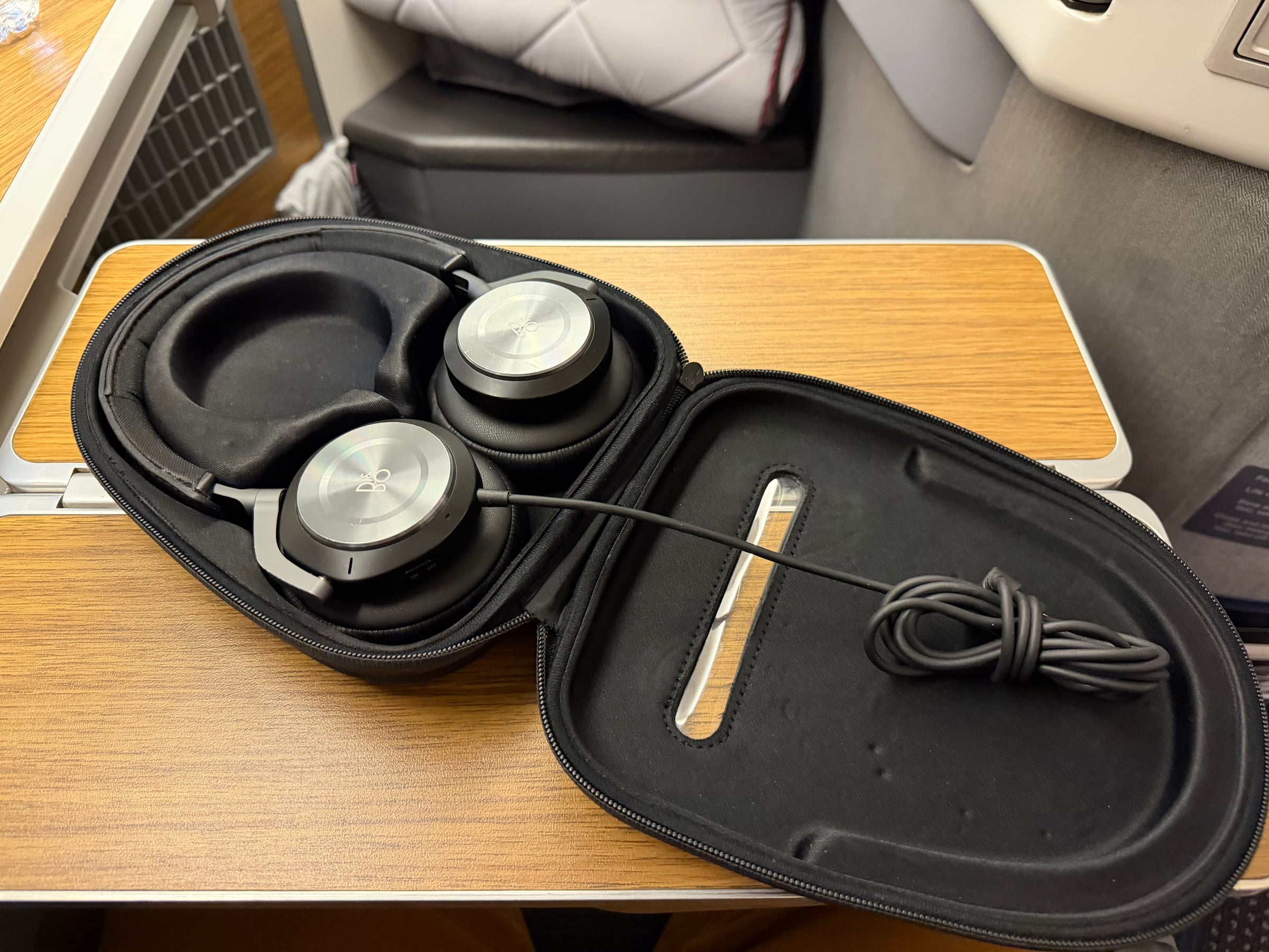 Bang and Olufsen headphones opened inside their hard case.