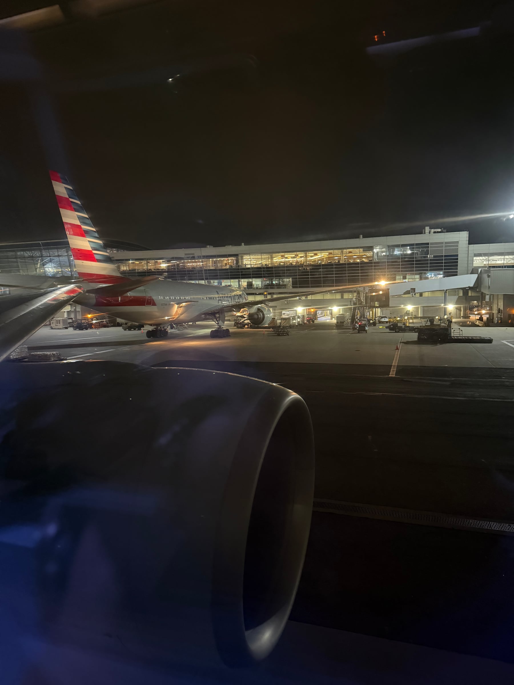 American Airlines 777 wing and another American aircraft at JFK before departure.
