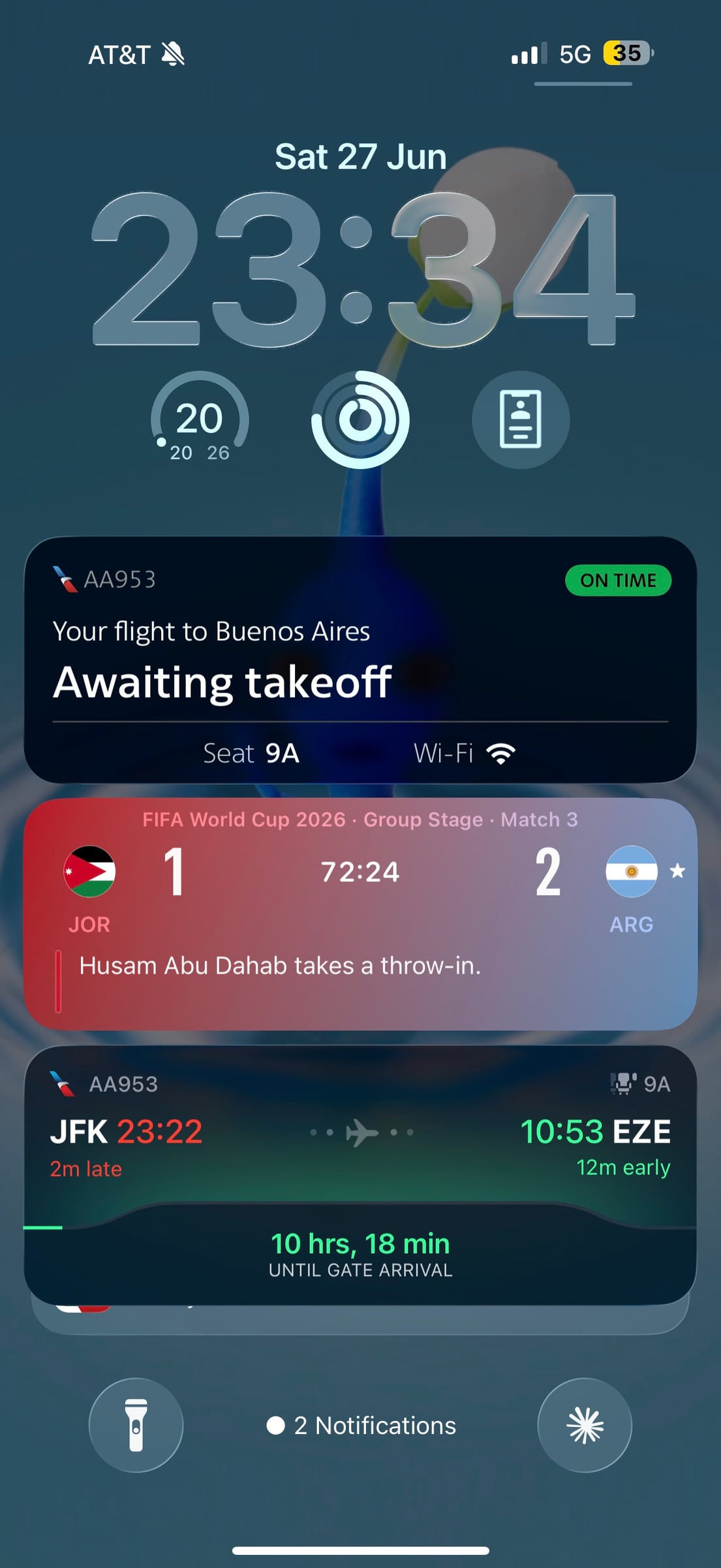 Phone screen showing AA953 flight status alongside the World Cup match score before takeoff.