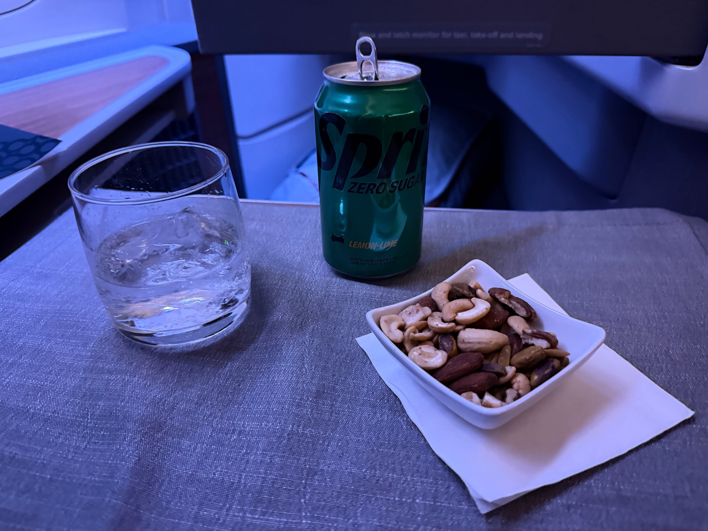 Warm mixed nuts and drinks served before dinner in Flagship Business.