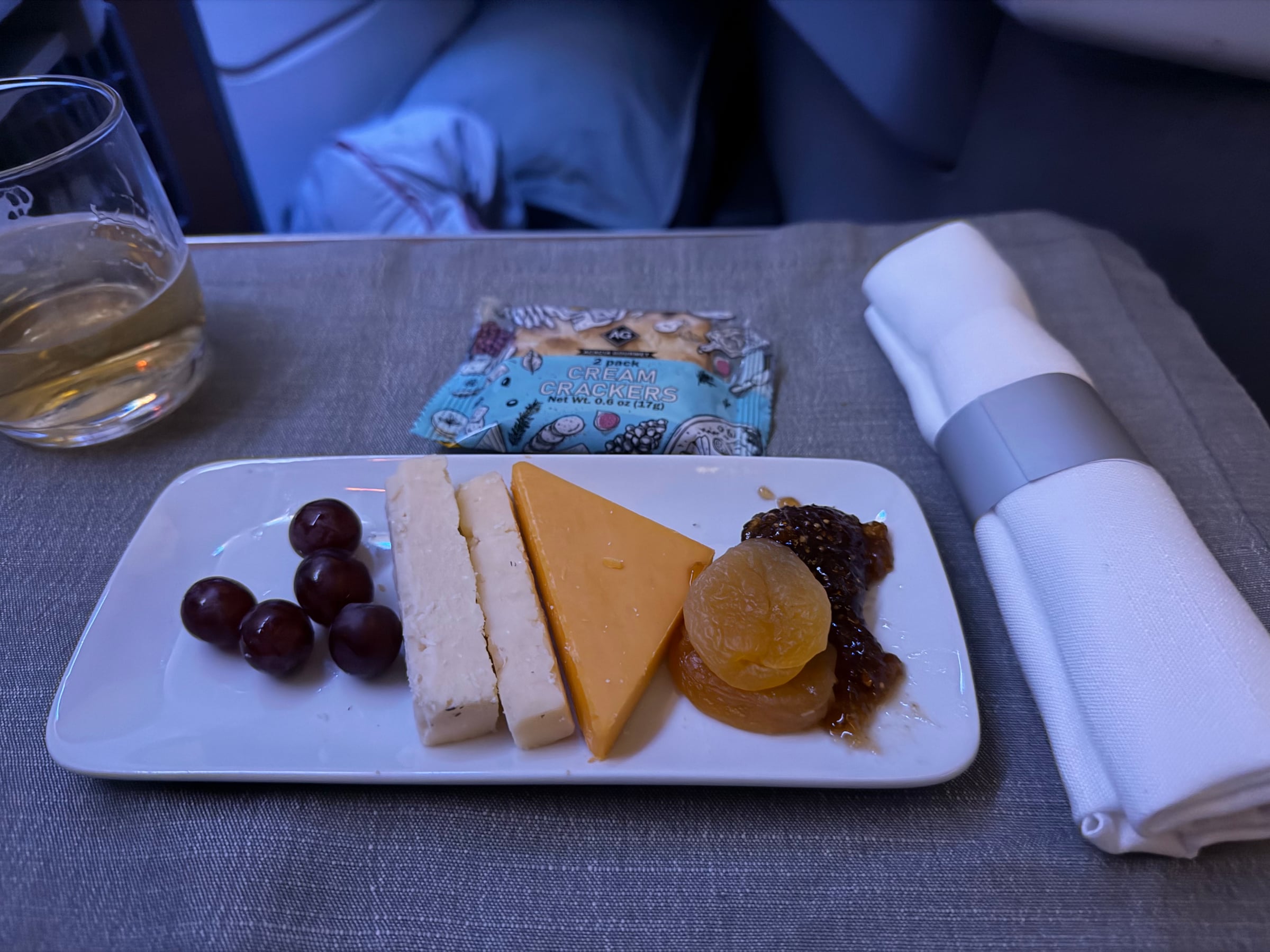 Cheese plate with crackers and grapes served for dessert in Flagship Business.