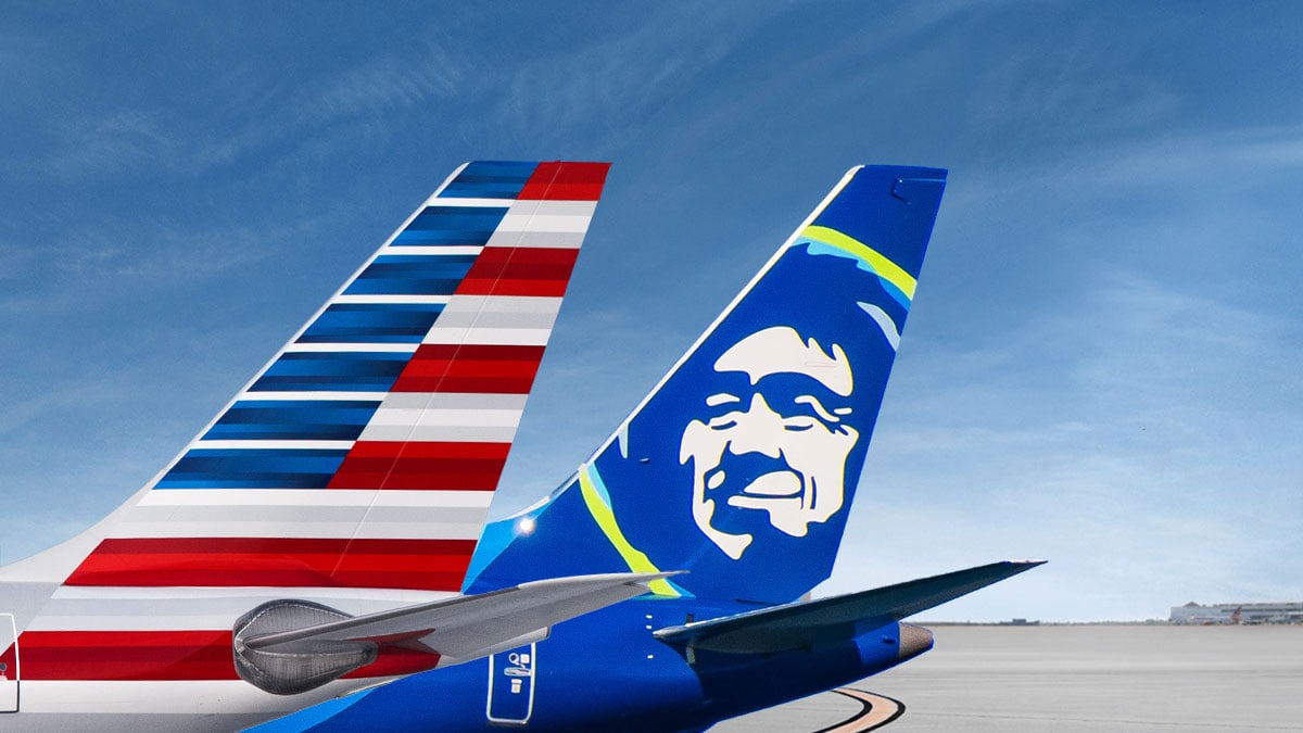 American Airlines and Alaska Airlines aircraft tails side by side.