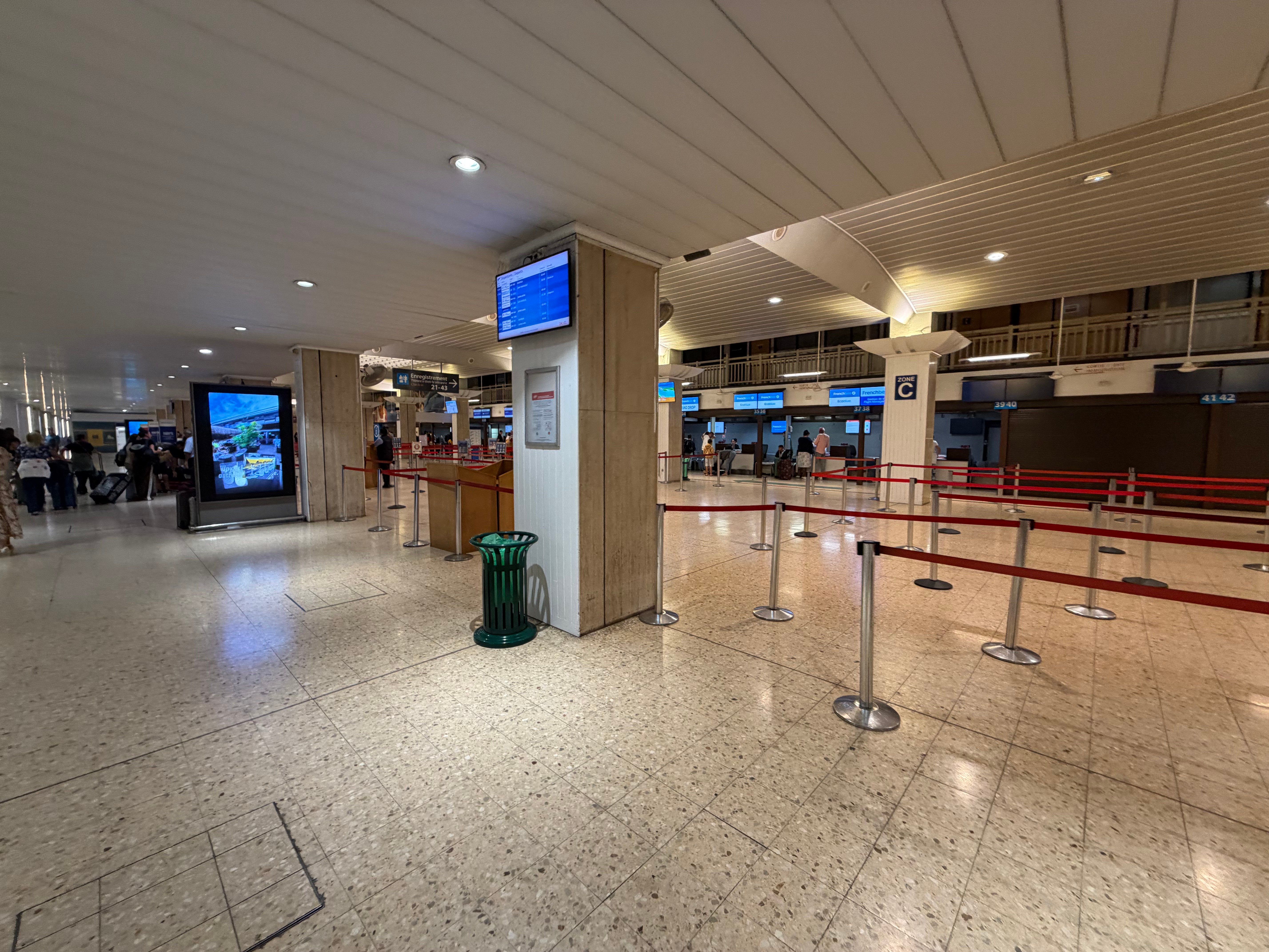 Open air check in hall at Papeete airport before sunrise.