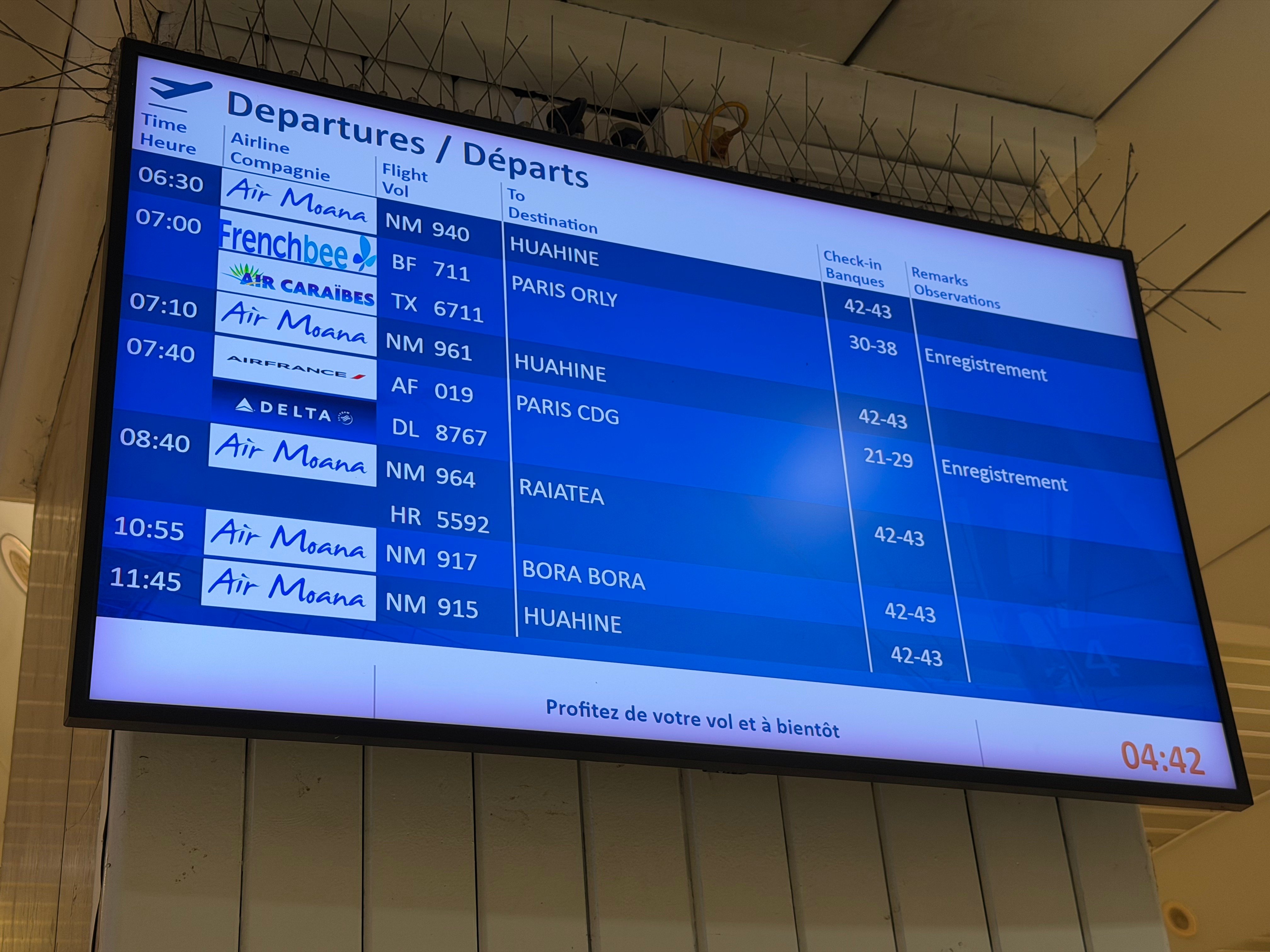 Early morning departures board at Papeete airport.