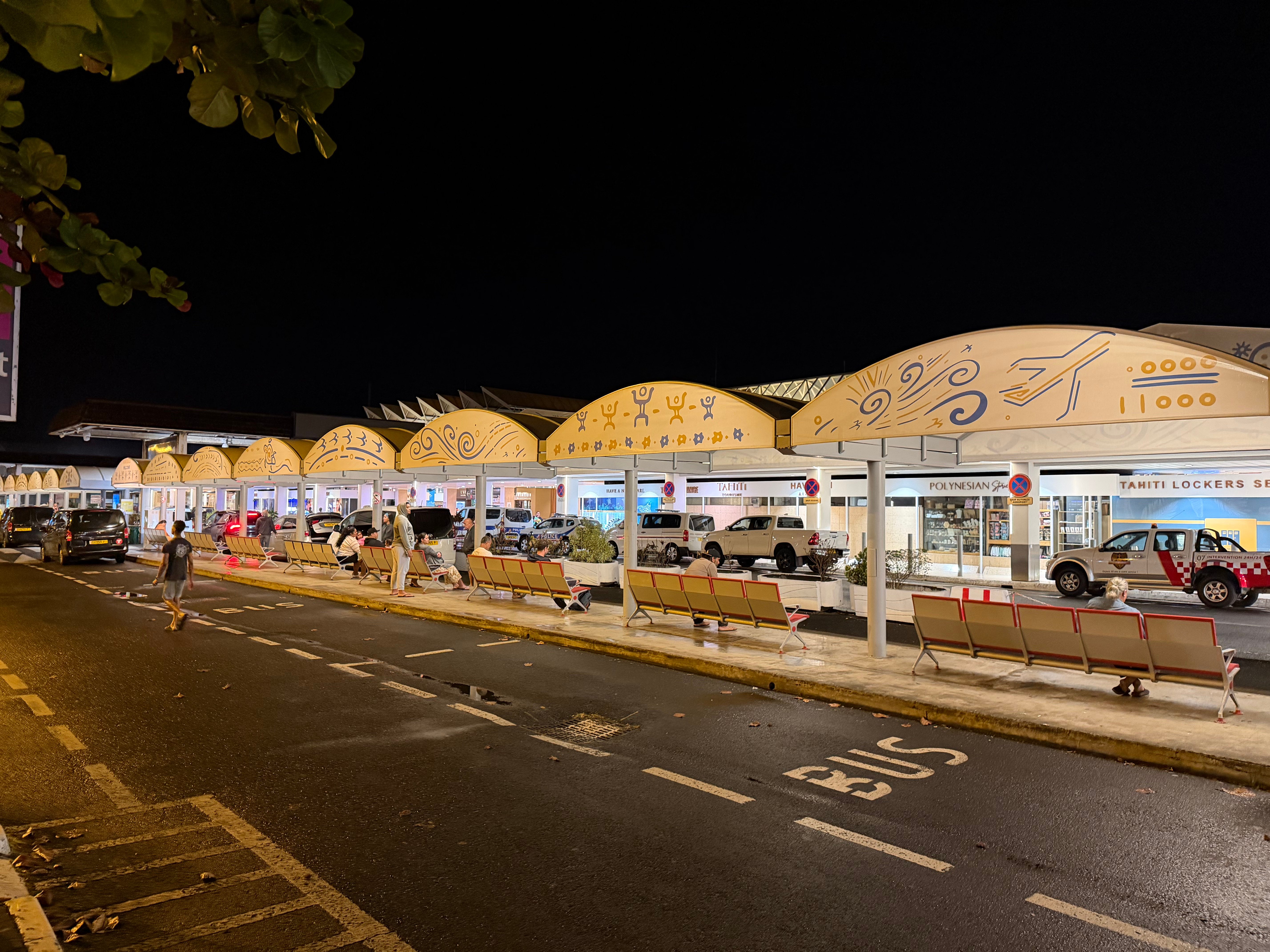 Exterior of the Tahiti Faa'a Airport terminal at night.