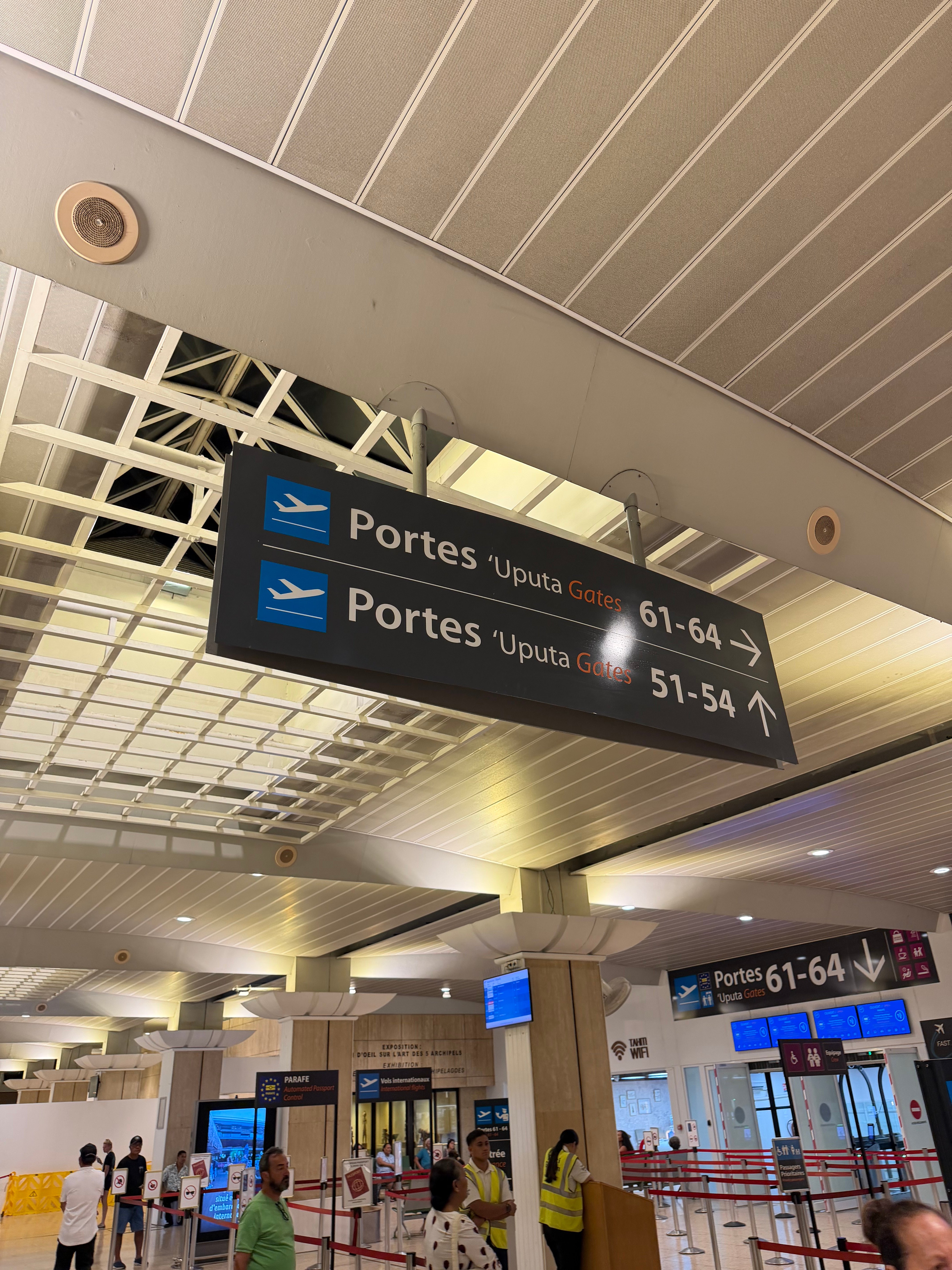 Signs pointing toward the international departure gates in Papeete.