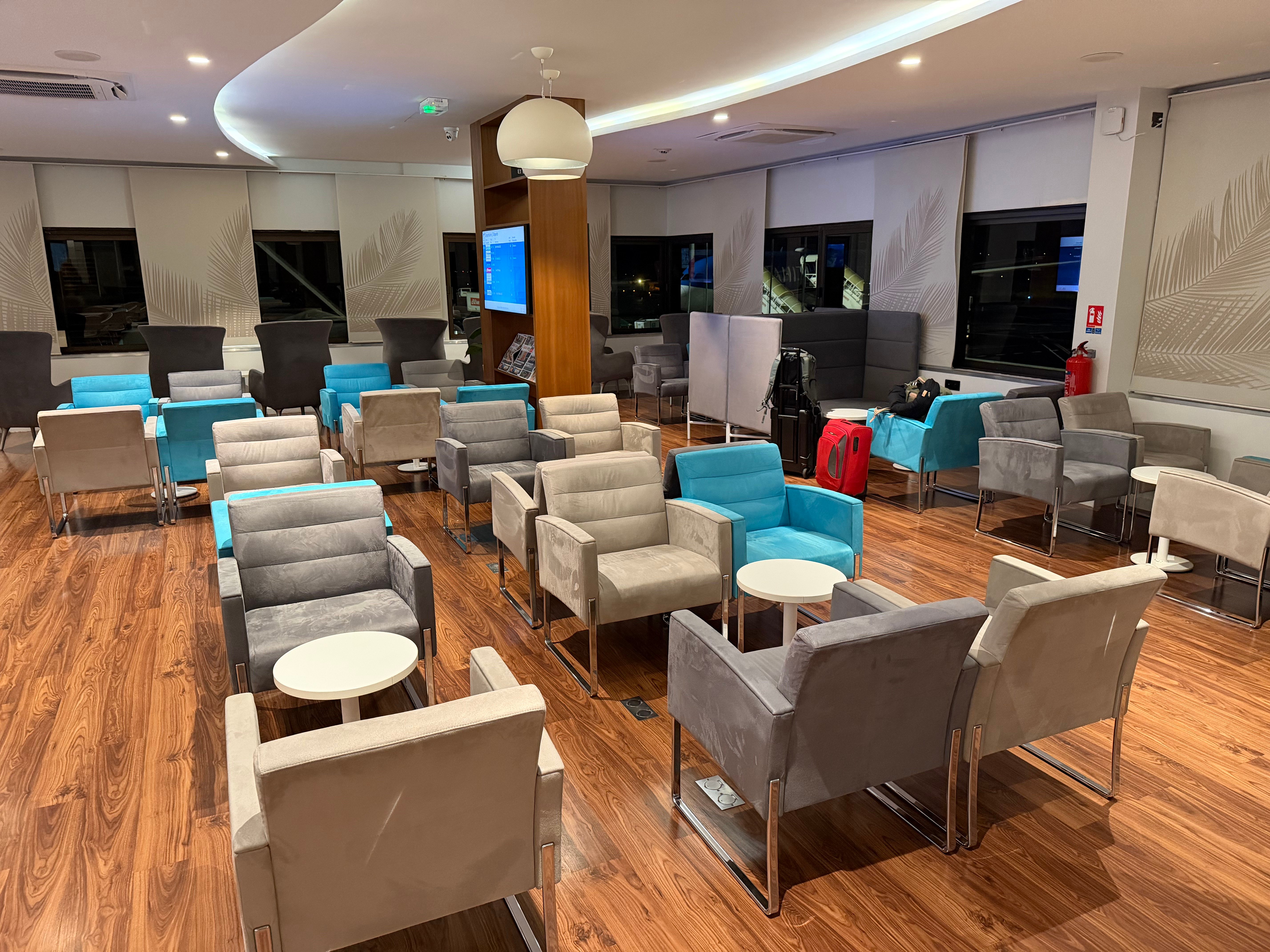 Armchairs and tables in the main Air Tahiti Nui lounge seating area.