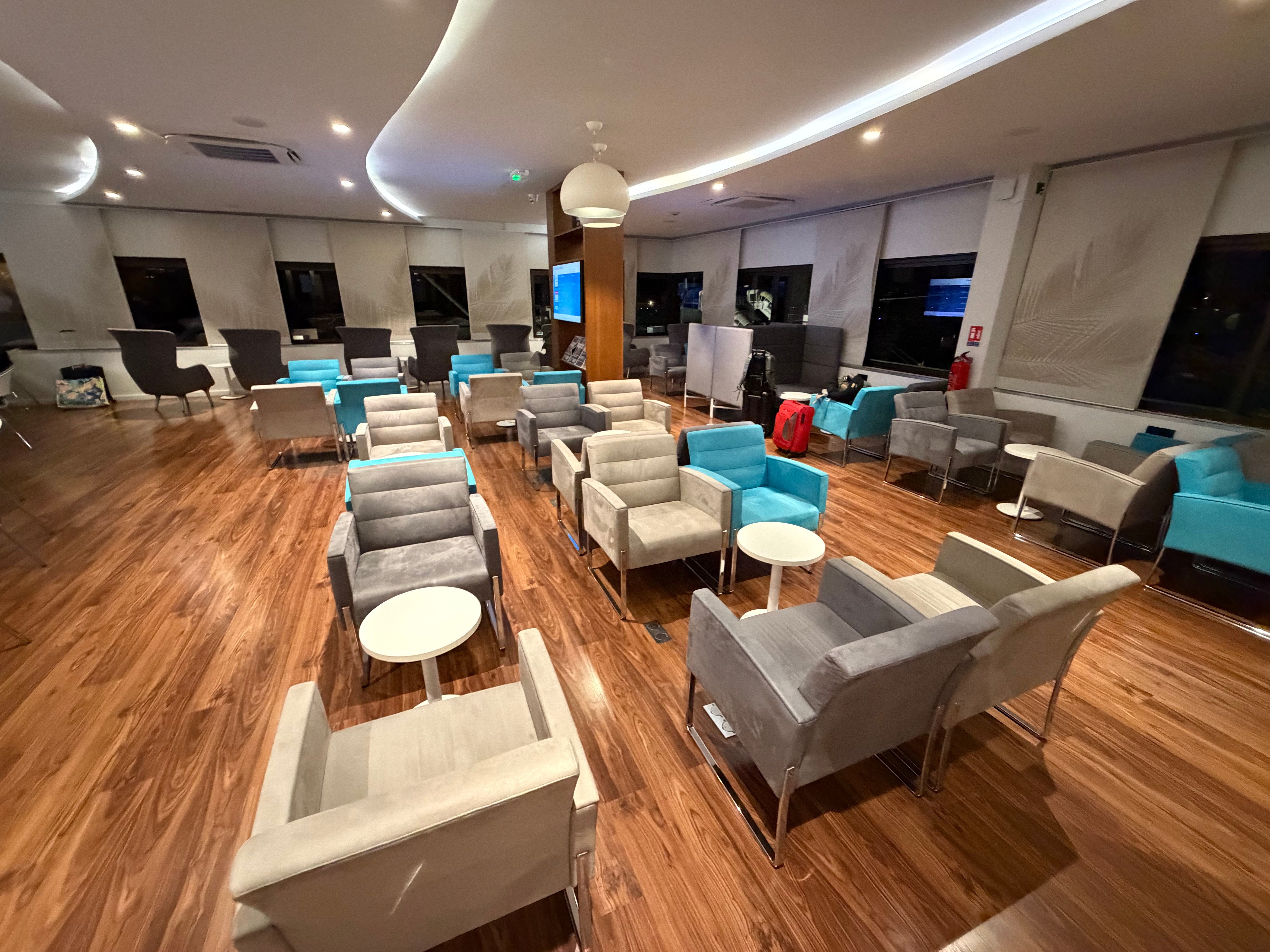 Upholstered armchairs and small tables in the lounge.