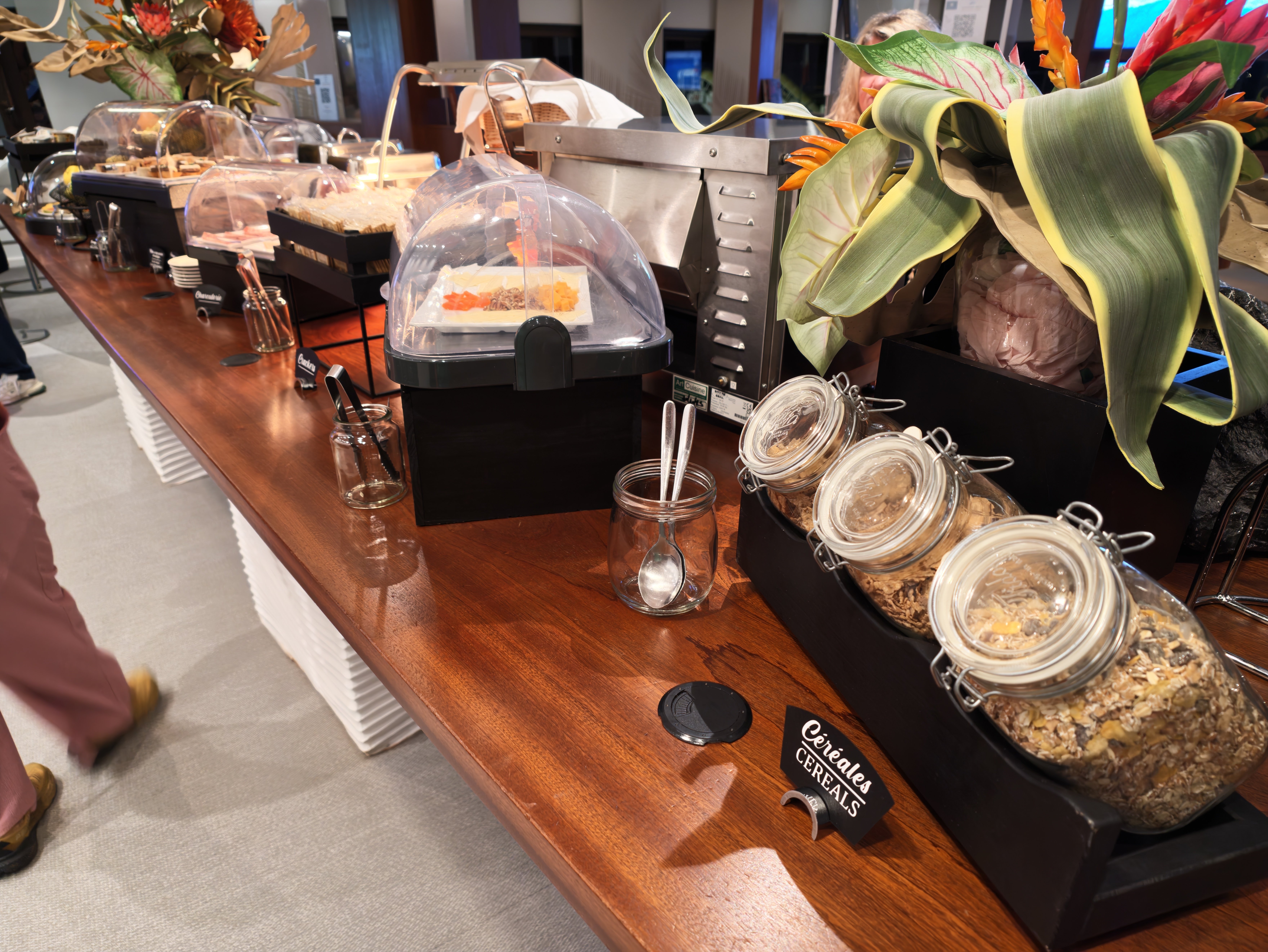Cereal dispensers and packaged snacks on the buffet.