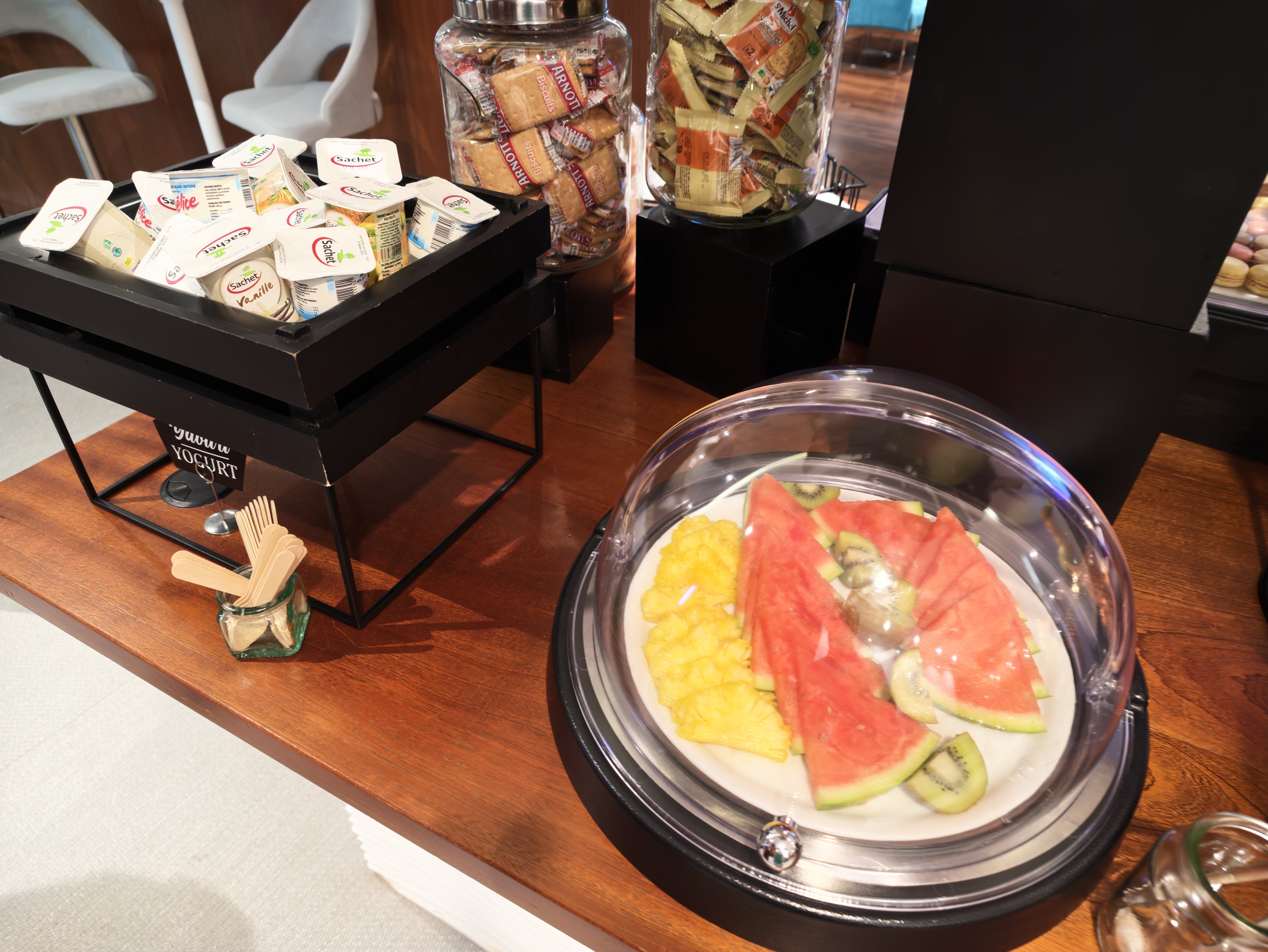 Fruit, yogurt, and sweet items at the lounge buffet.