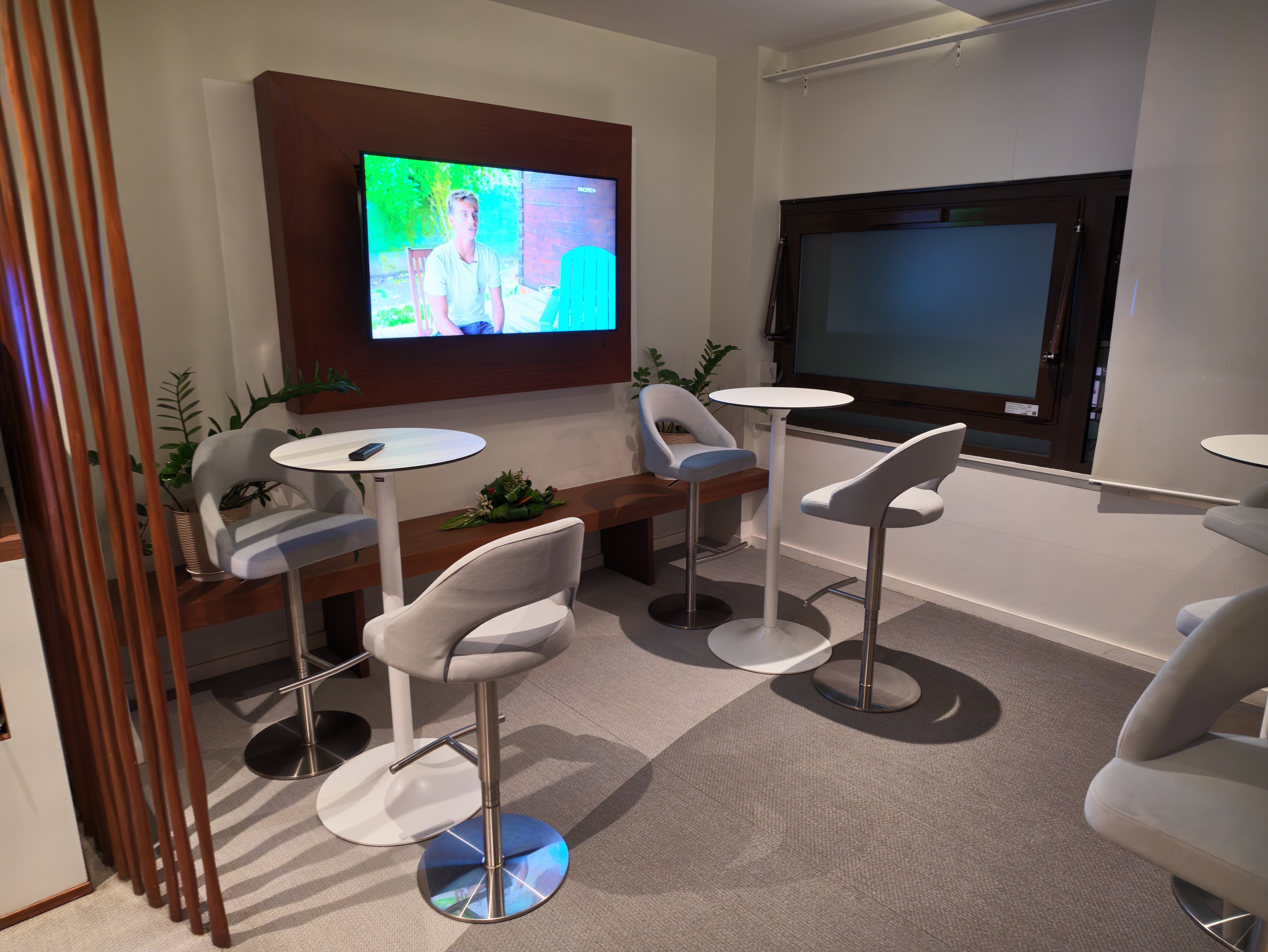 Additional lounge room with tables and a television.