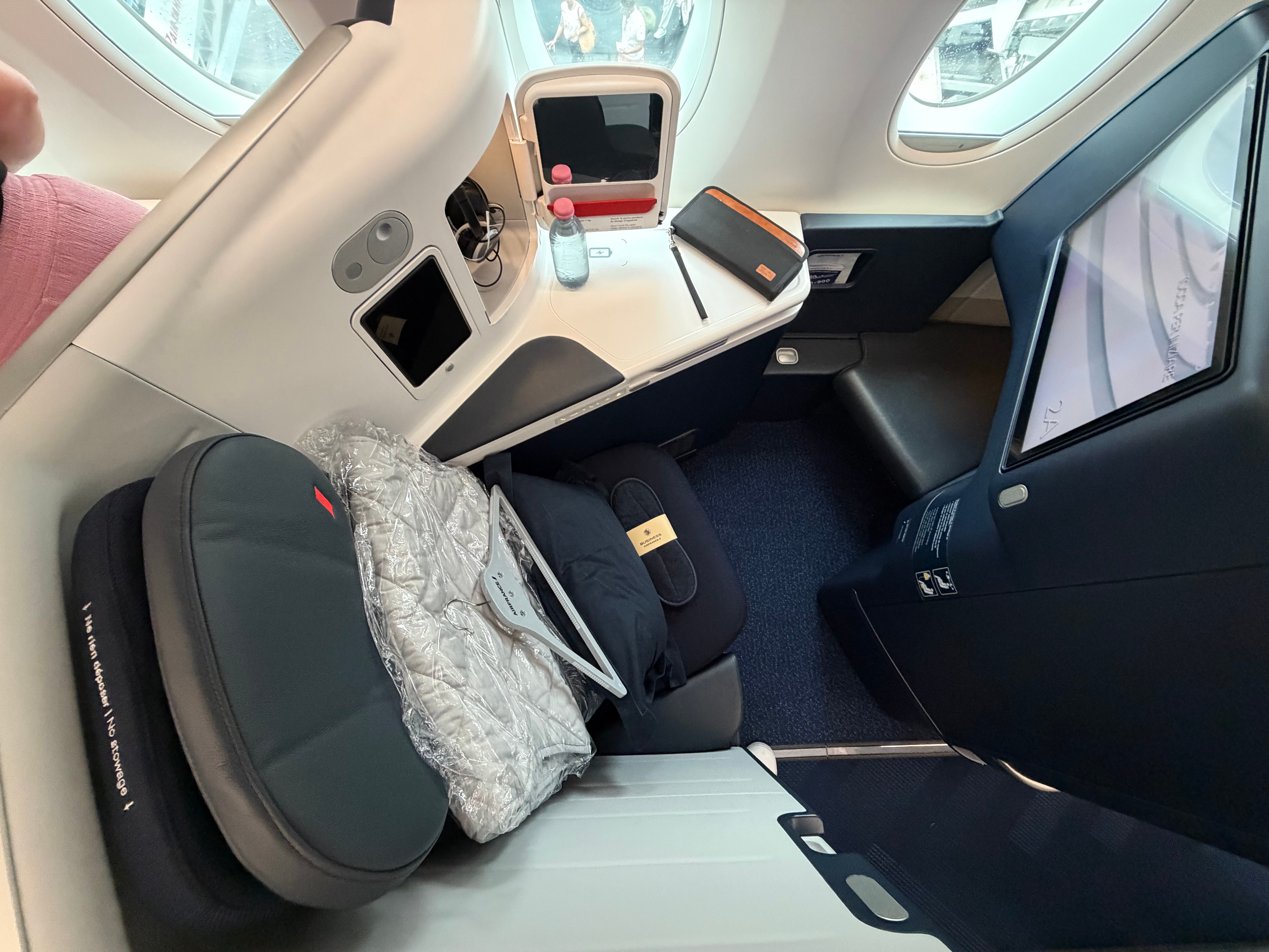 Wide view of a Business Class seat and side console.
