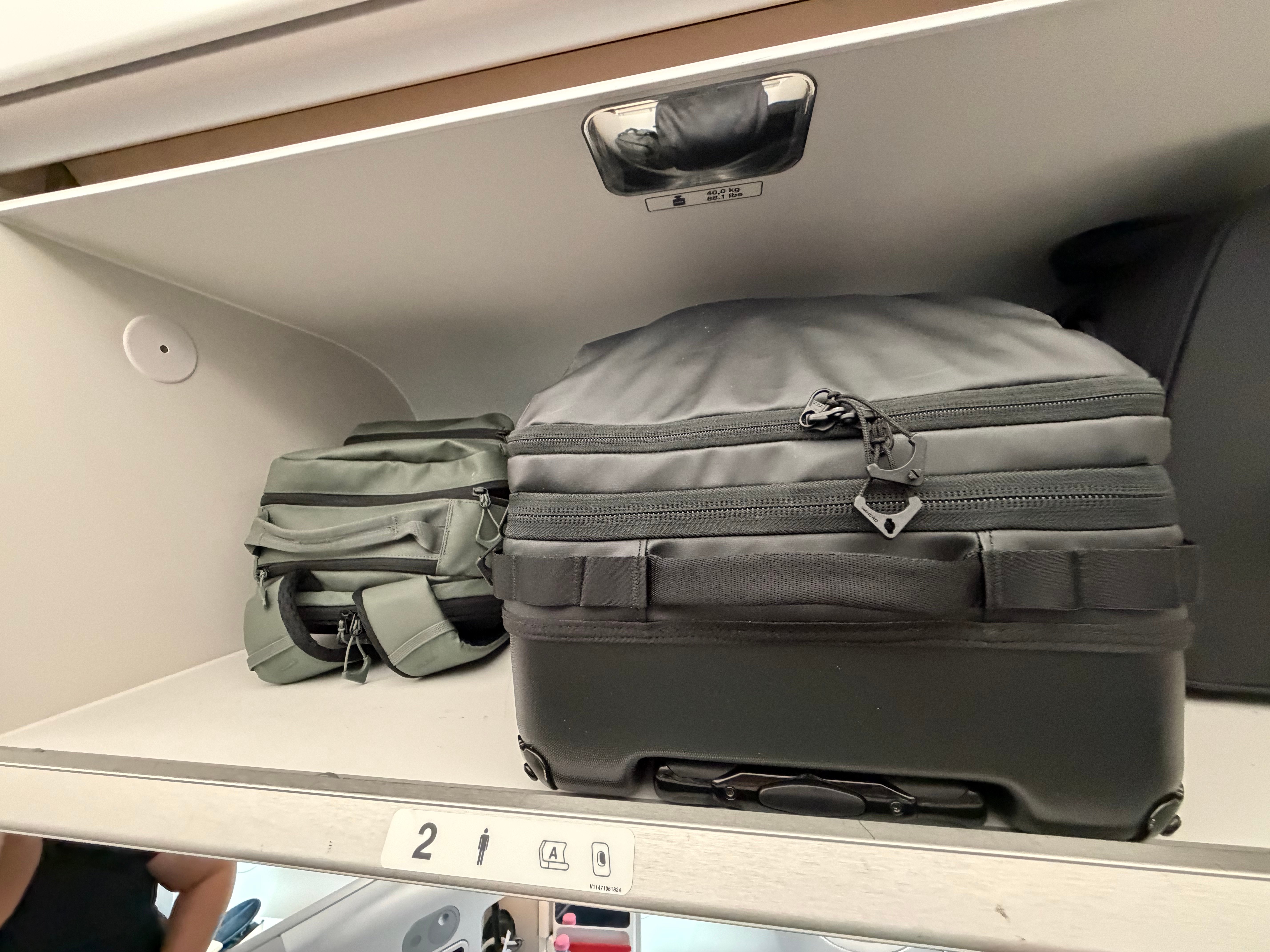 Overhead bin with my carry on bags.