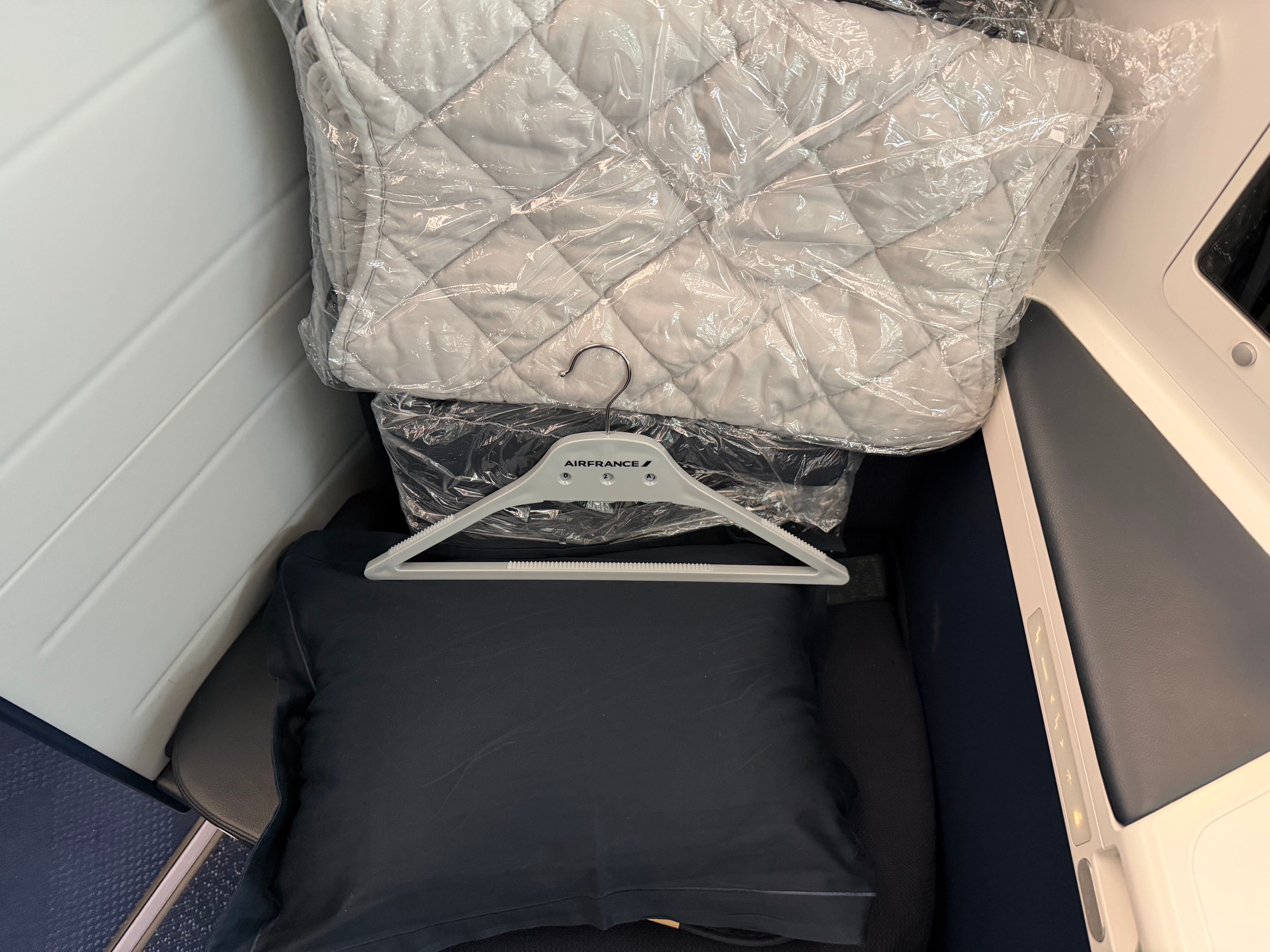 Pillow and wrapped bedding waiting at the seat.