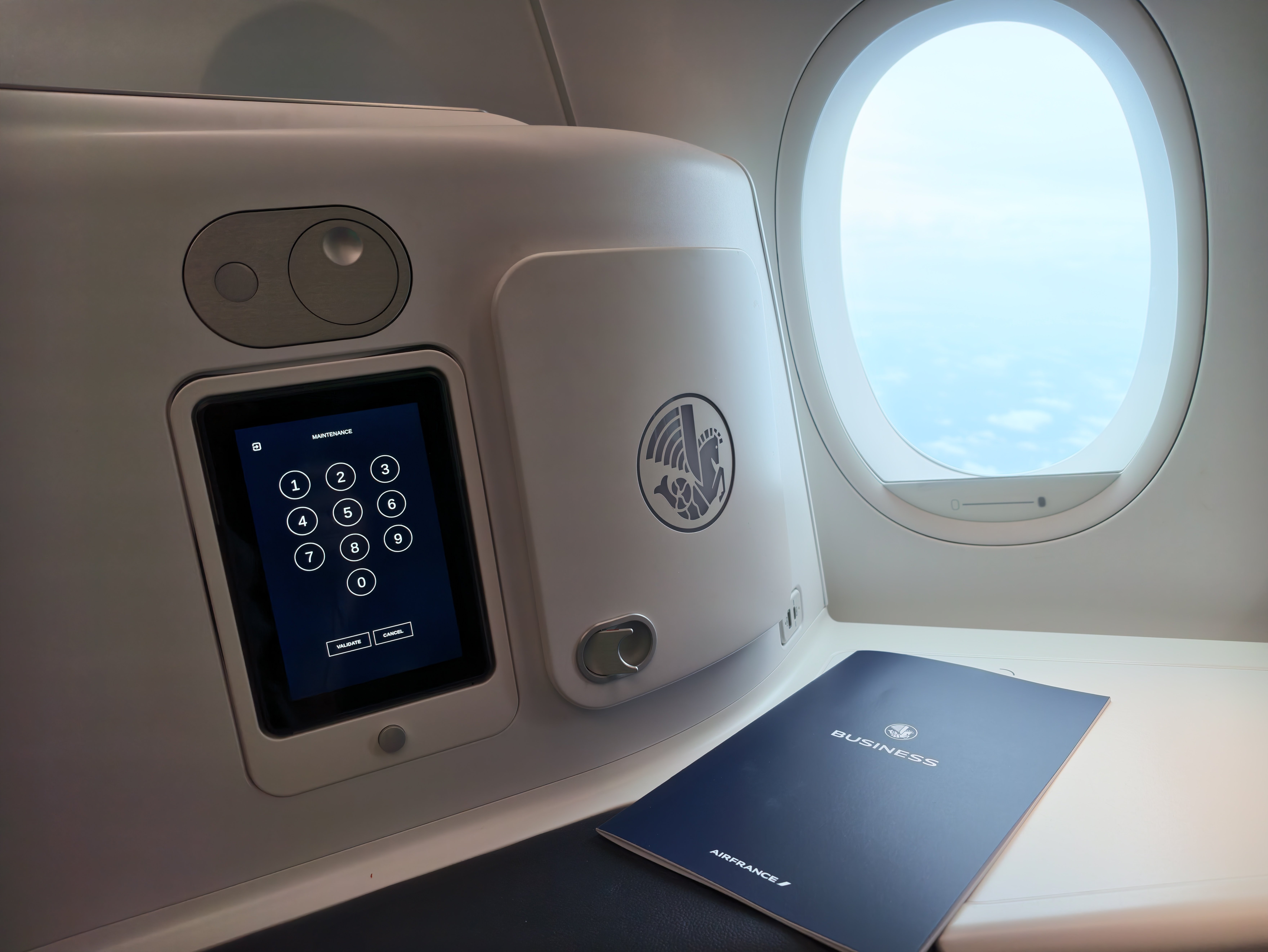 Seat control screen beside the dimmable window.
