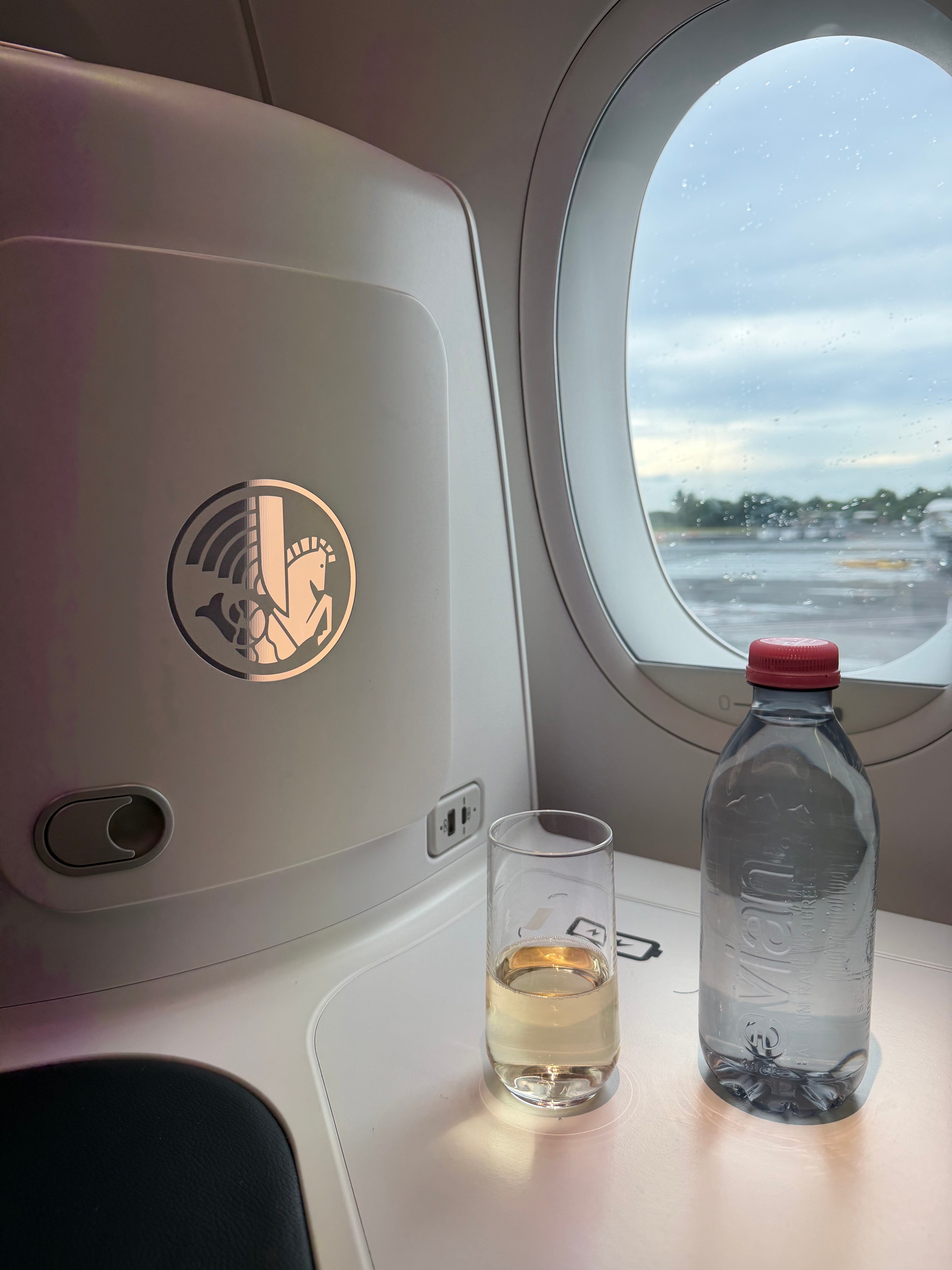 Welcome champagne and a bottle of water on the side table.
