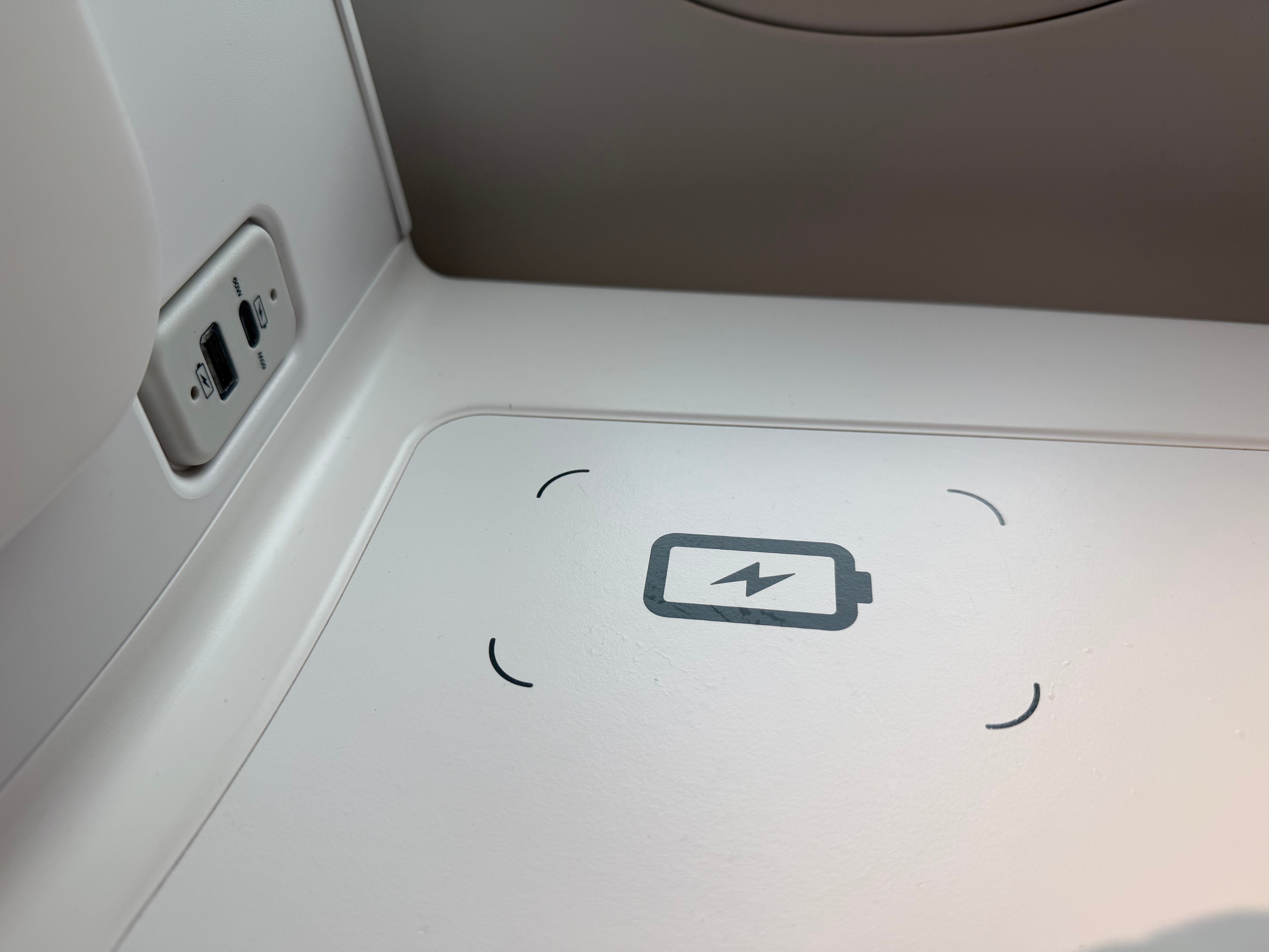 Wireless phone charging pad built into the side table.
