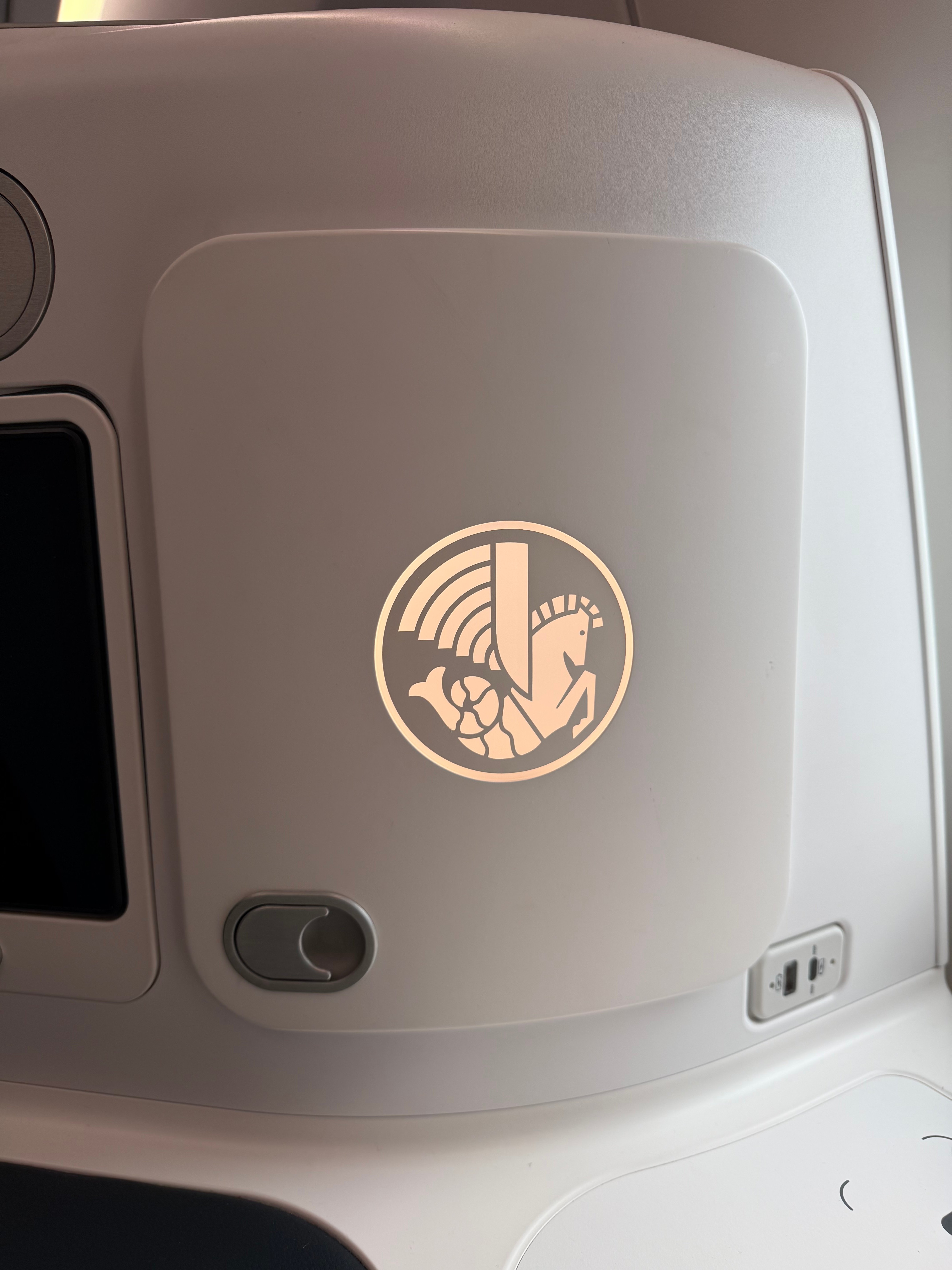 Reading light beside the illuminated winged seahorse logo.