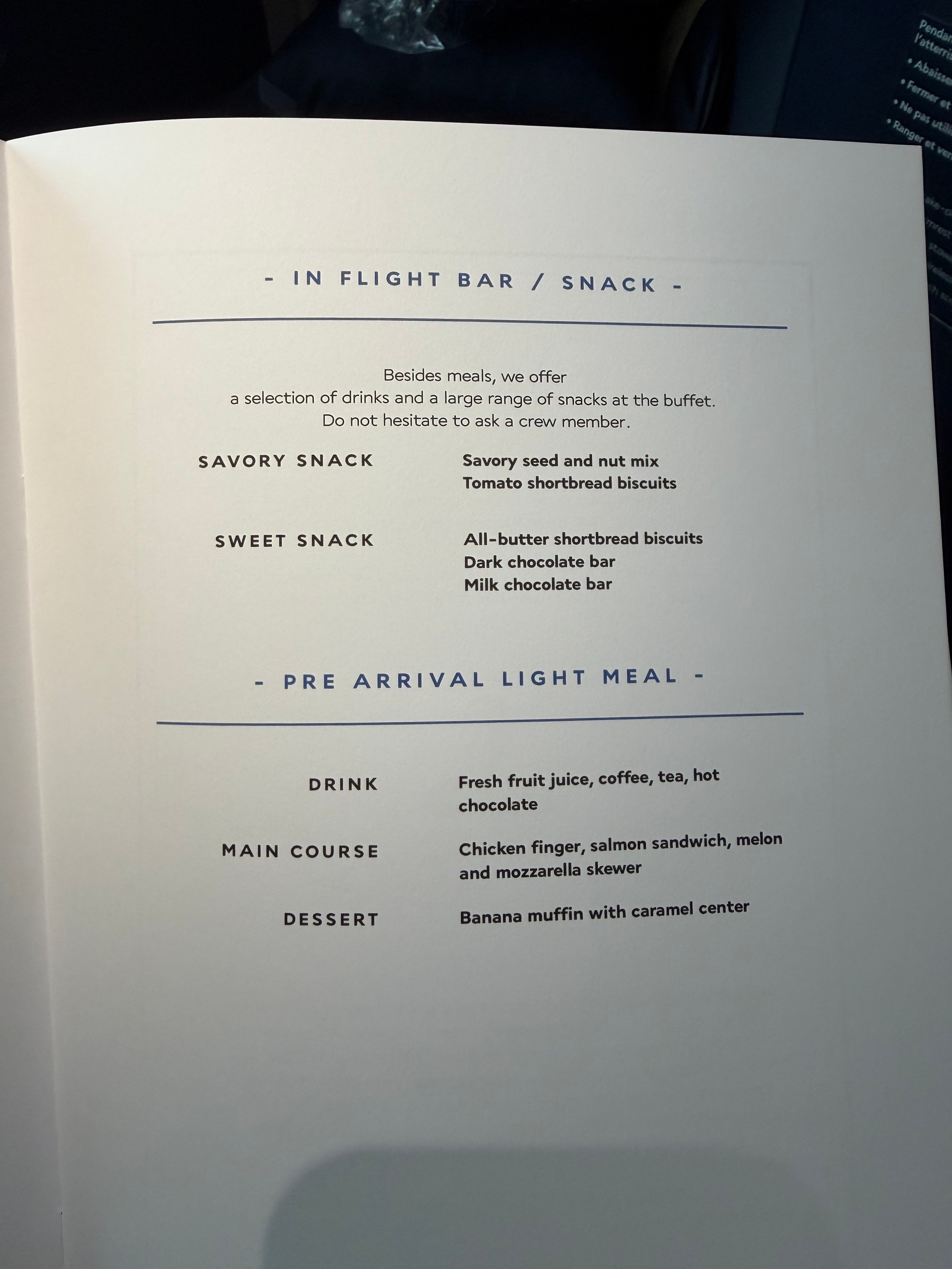 Menu listing galley snacks and the light meal before arrival.