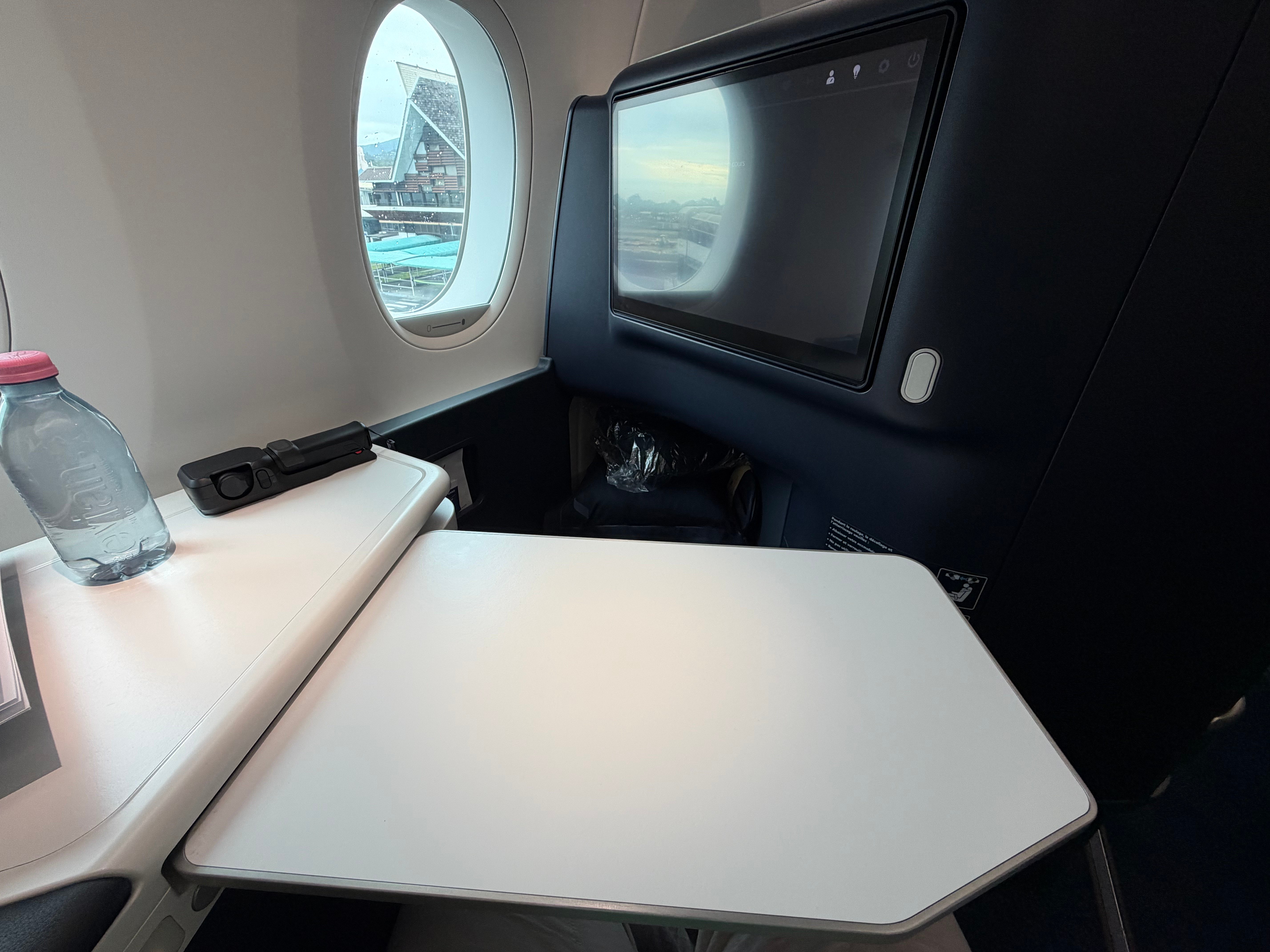 Air France Business Class suite with the tray table open.