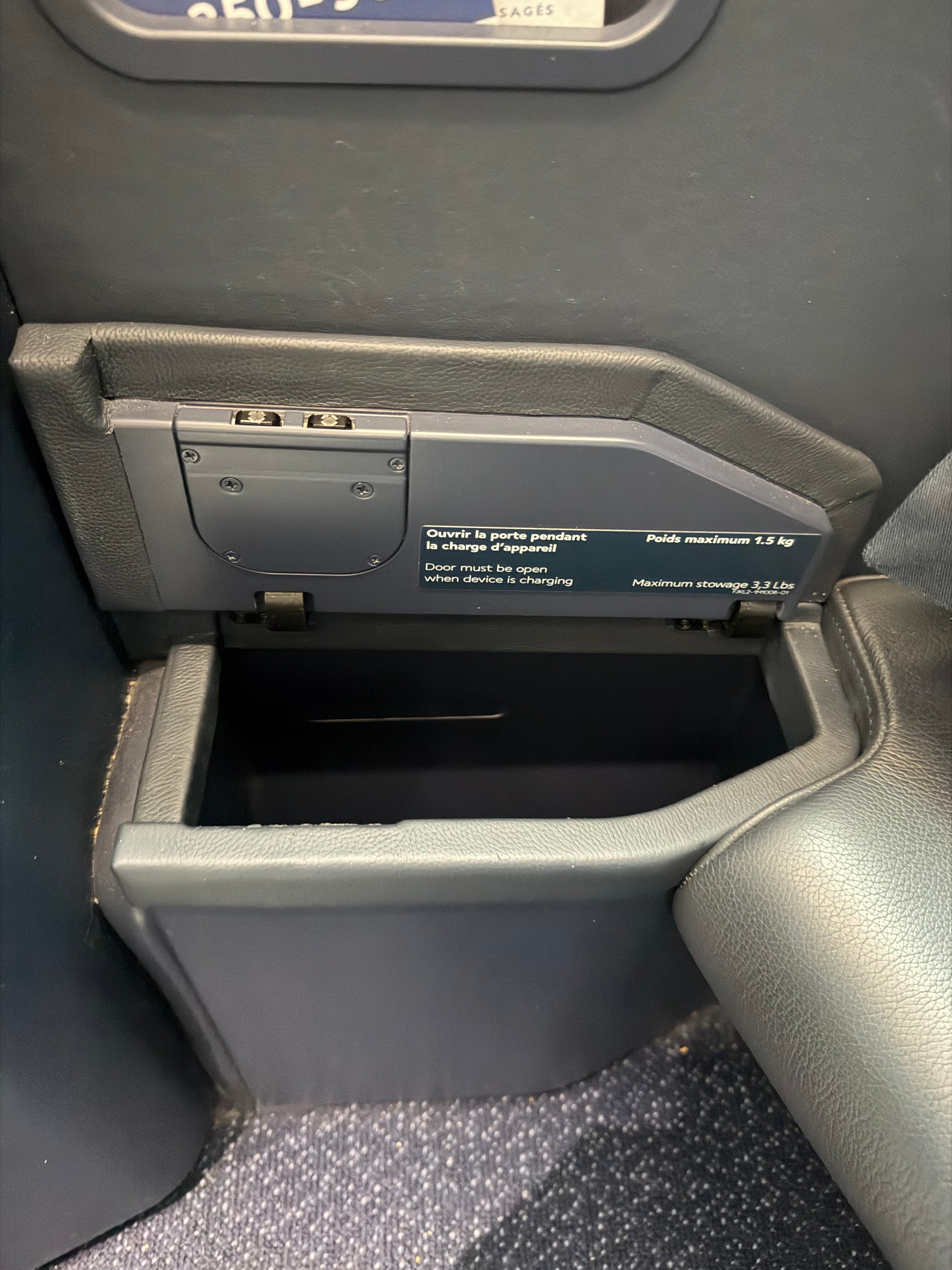 Small storage compartment beside the aisle.