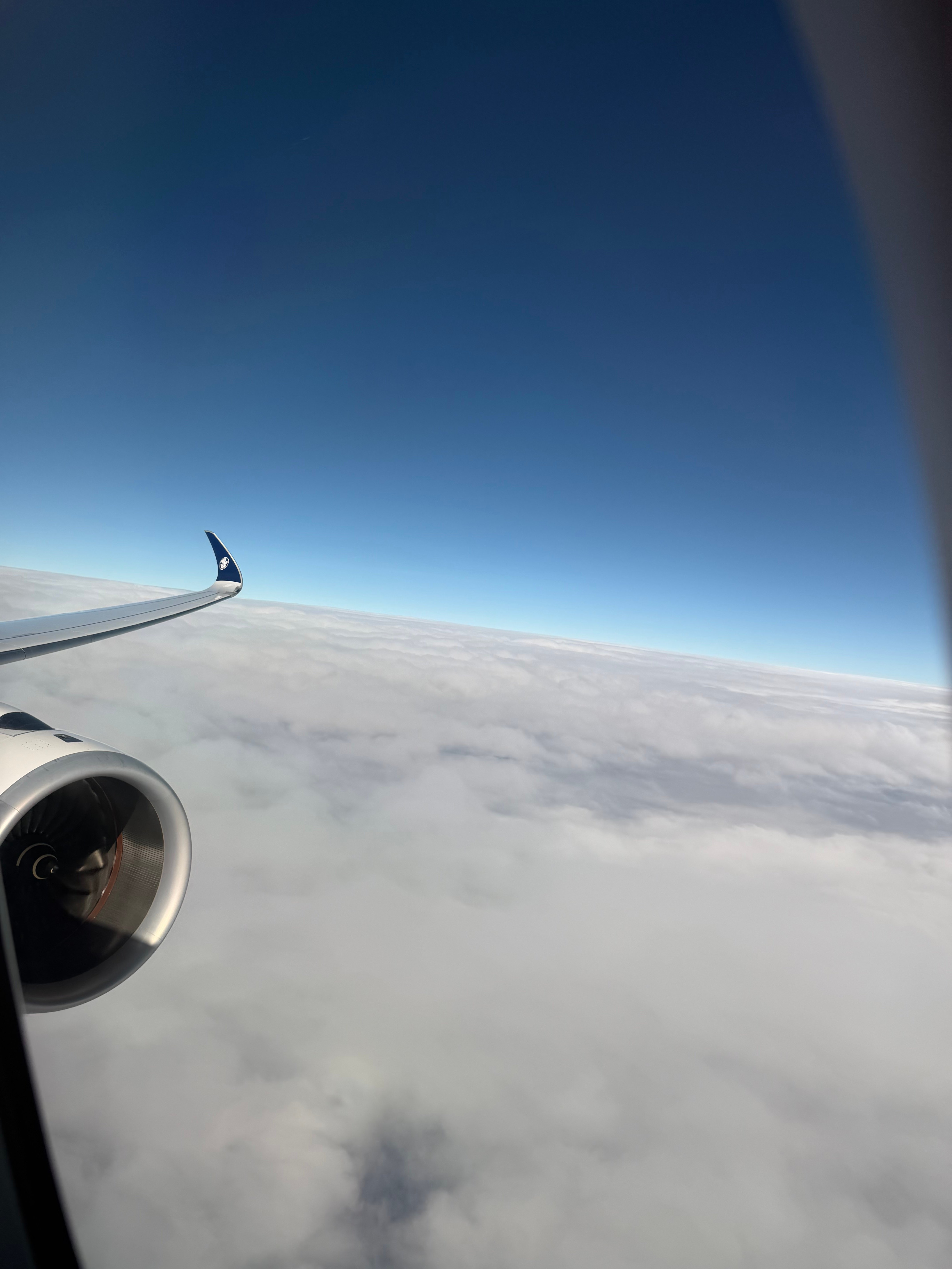 A350 engine and wing above the clouds.
