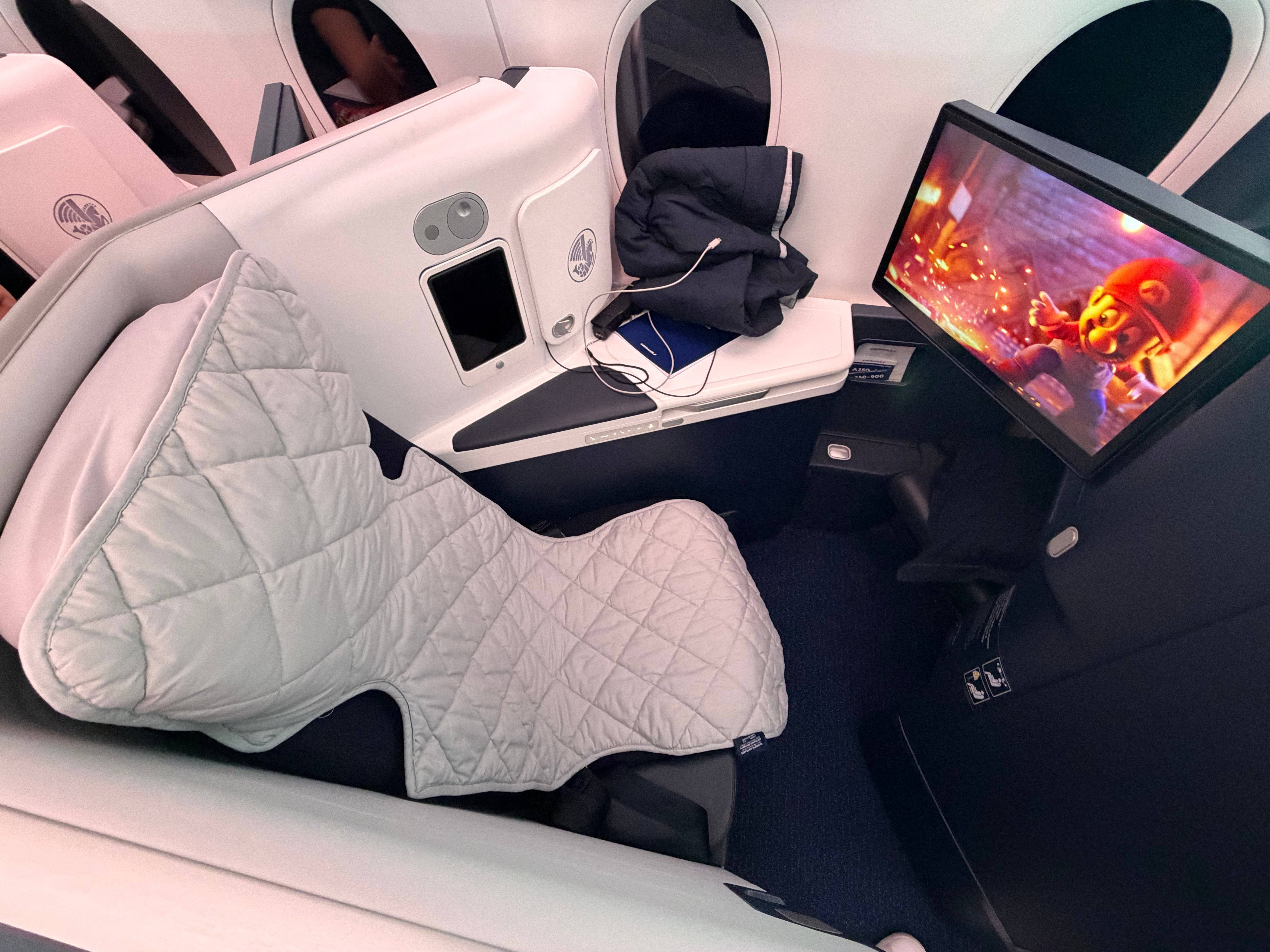 Business Class seat prepared for sleep with the mattress pad.