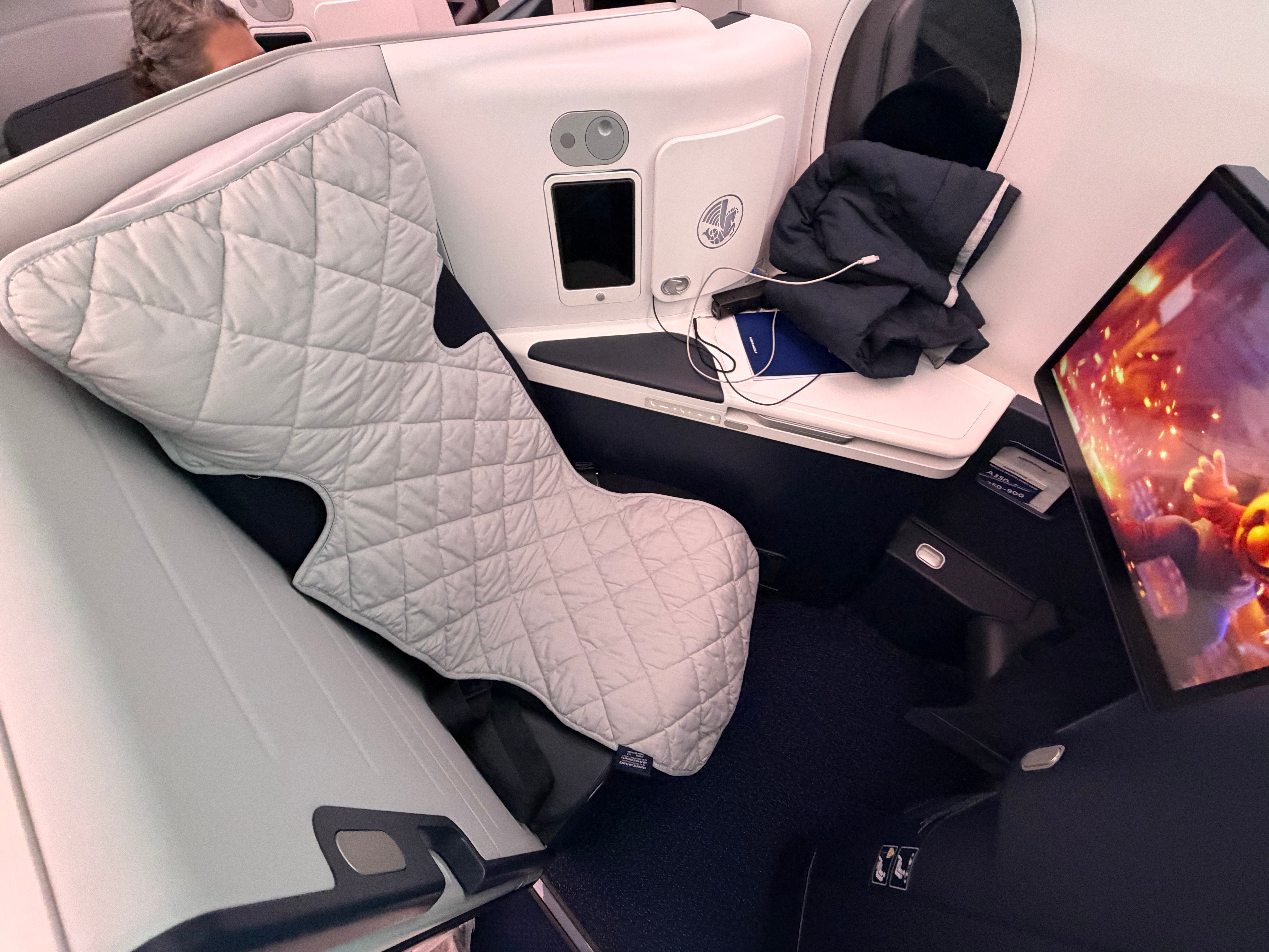 Pillow and mattress pad on the reclining seat.